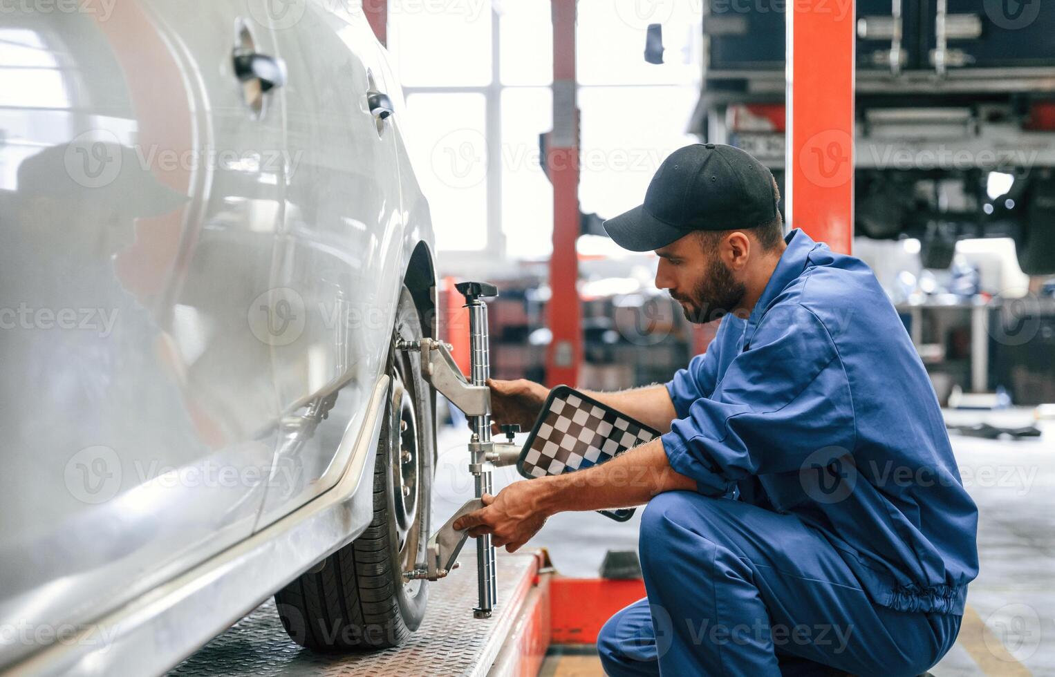 Taking ,care ,of ,wheel disk. Auto mechanic working in garage. Repair service photo