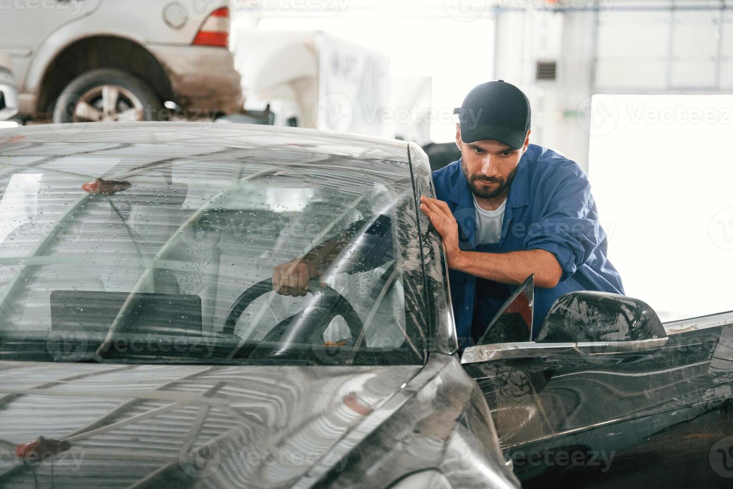 Moving ,the dirty car that need washing. Auto mechanic working in garage. Repair service photo