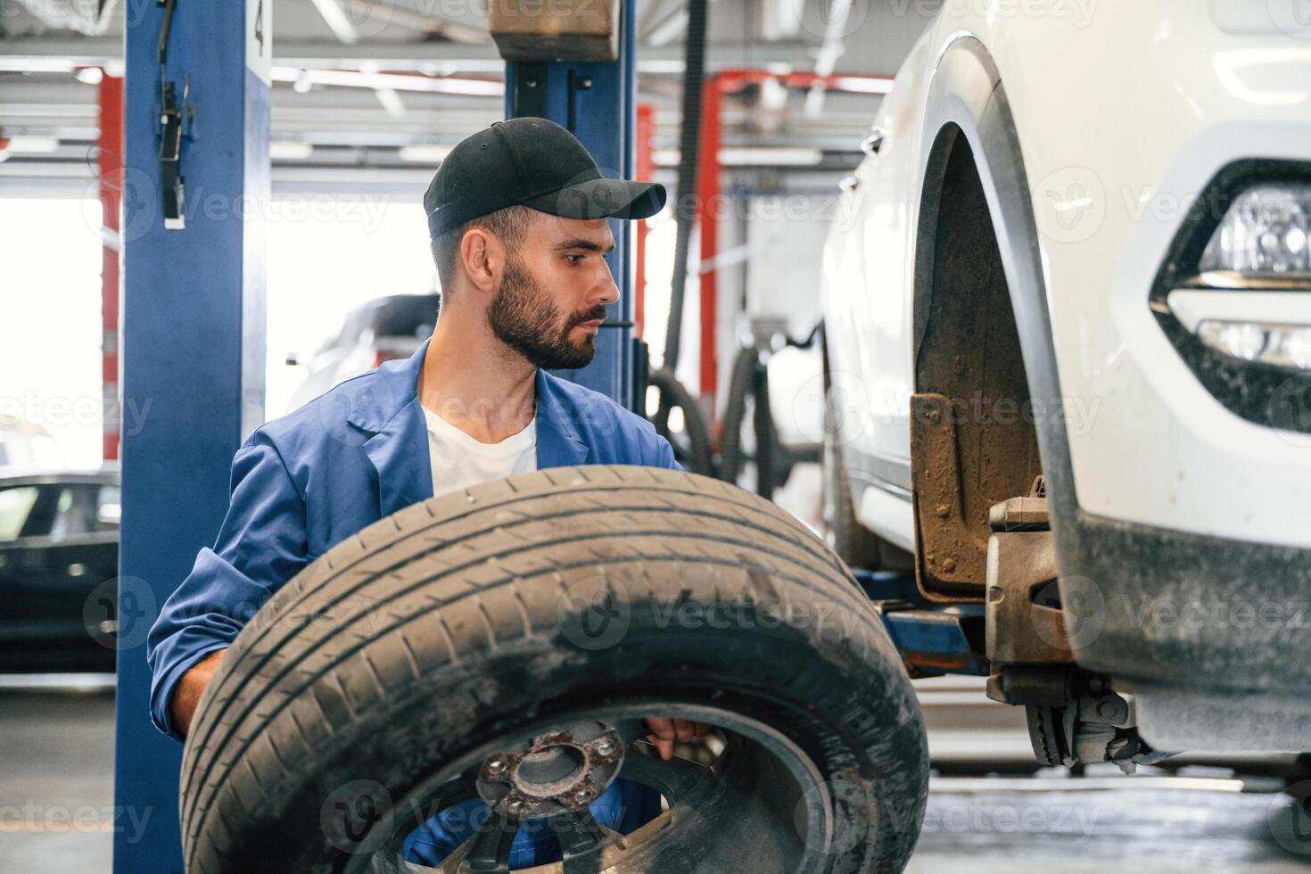 Auto, mechanic working in garage. Repair service photo
