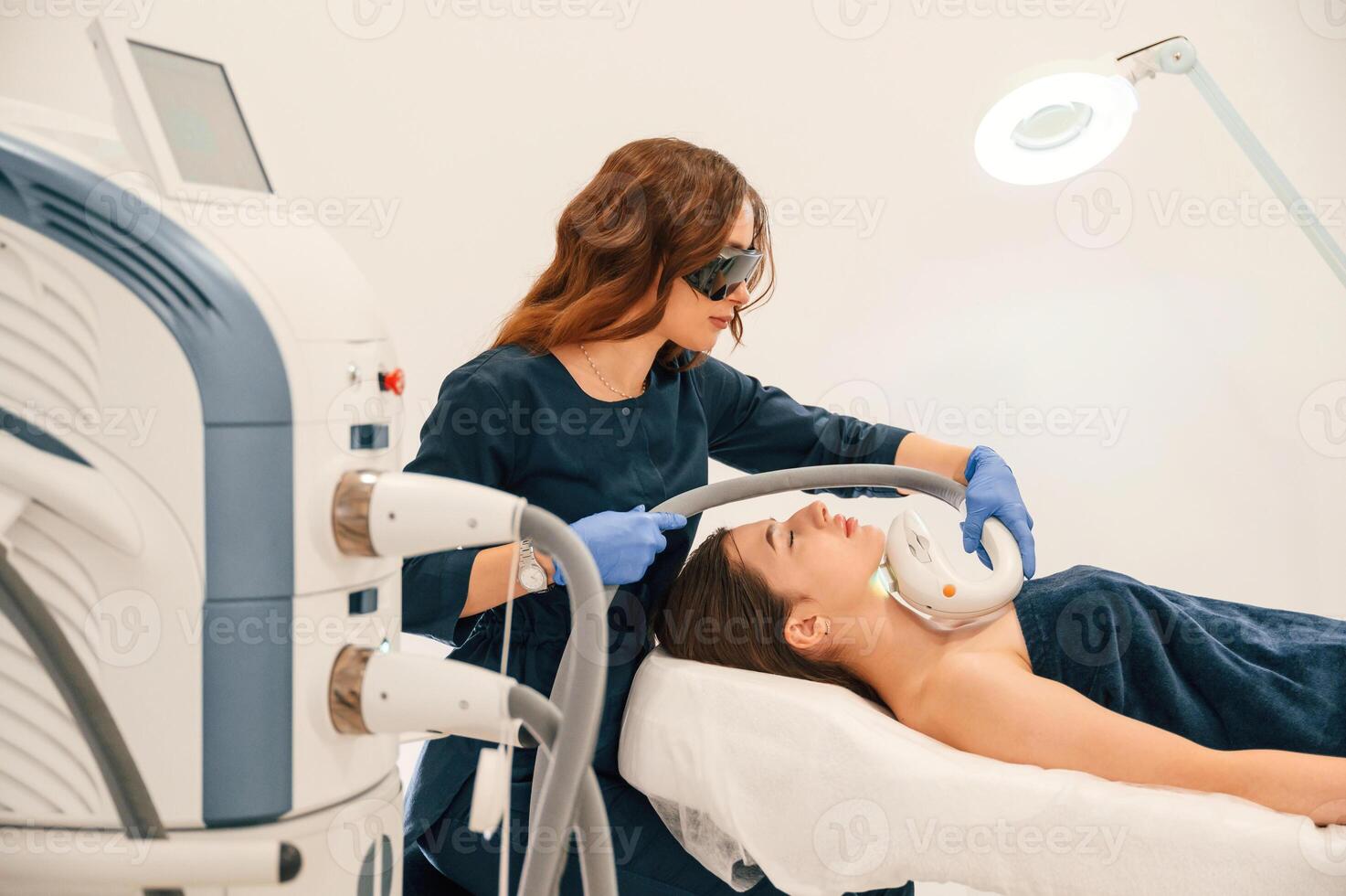 Woman ,is getting LPG, hardware massage in beauty salon. Getting photo rejuvenation procedure at cosmetology clinic