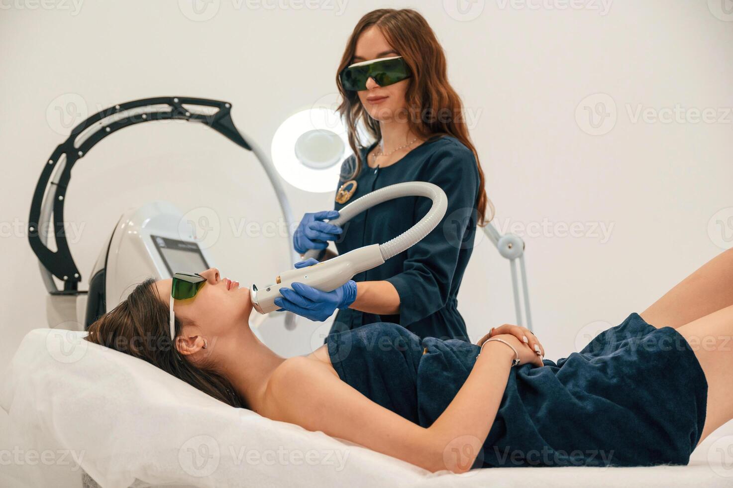 Professional occupation. ,Getting photo rejuvenation procedure at cosmetology clinic. Women in beauty salon