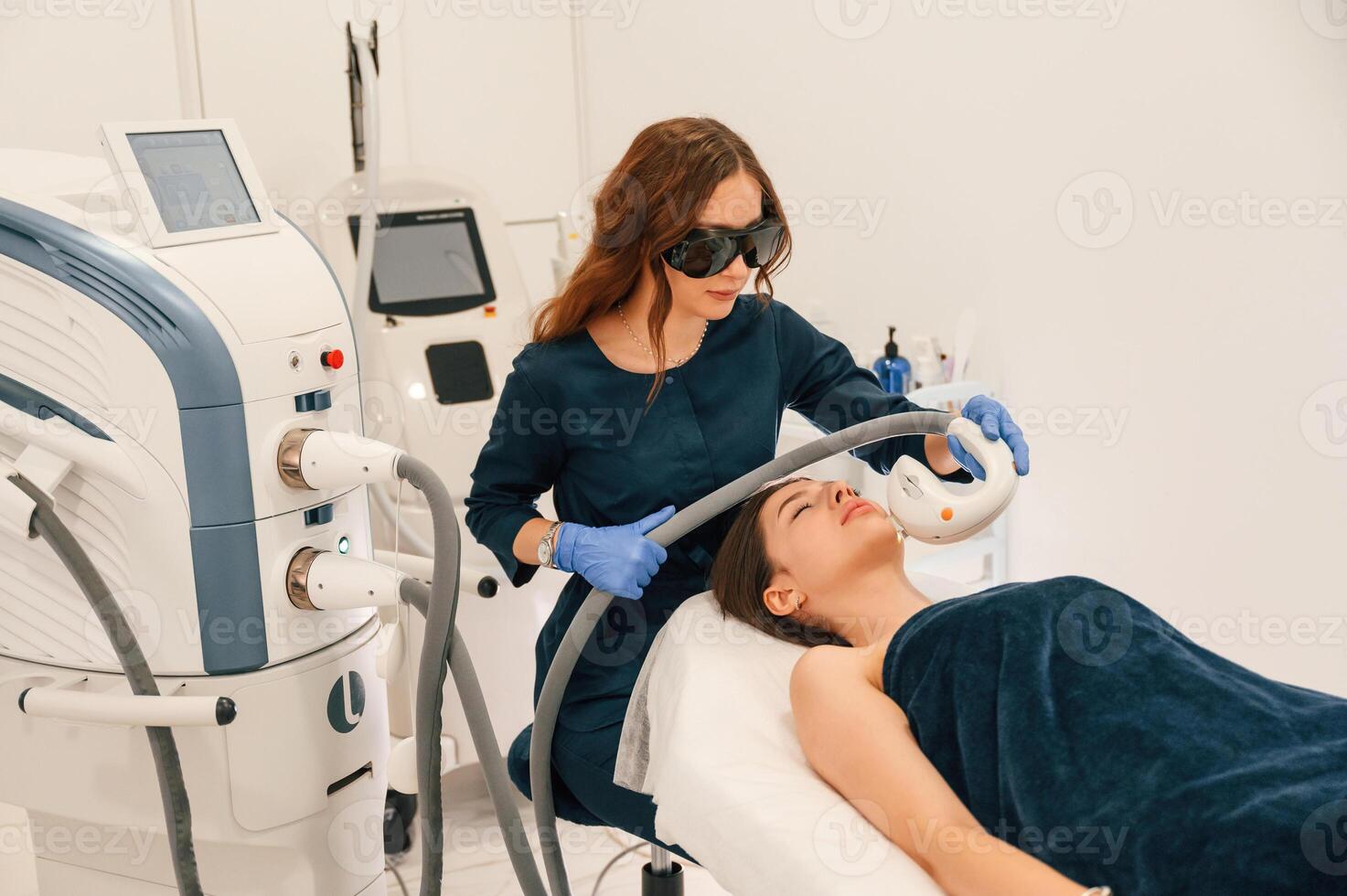 In protective eyewear. Getting photo, rejuvenation procedure at cosmetology clinic photo