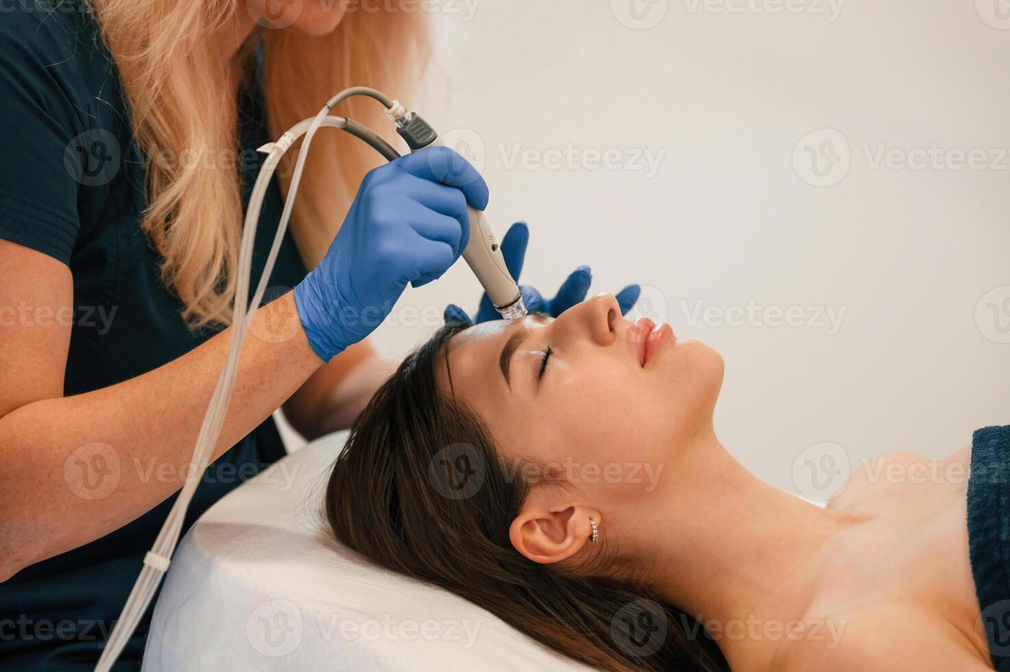 Procedure on the face.. Getting photo rejuvenation at cosmetology clinic. Women in beauty salon