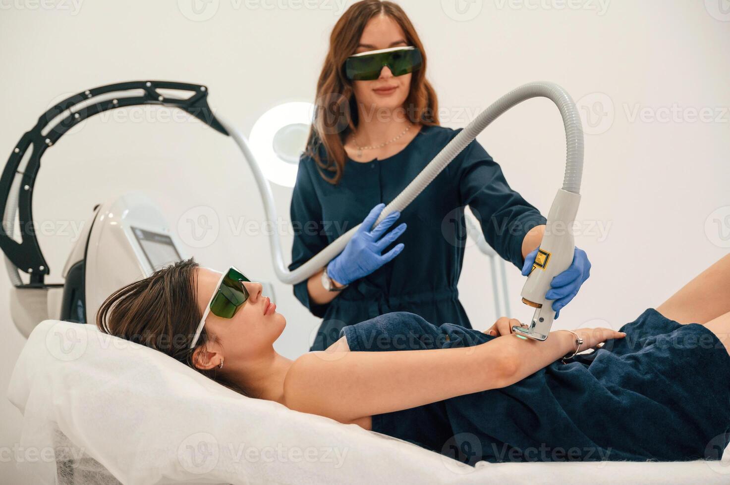 Procedure on the hands. Getting photo rejuvenation at cosmetology clinic. Women in beauty salon