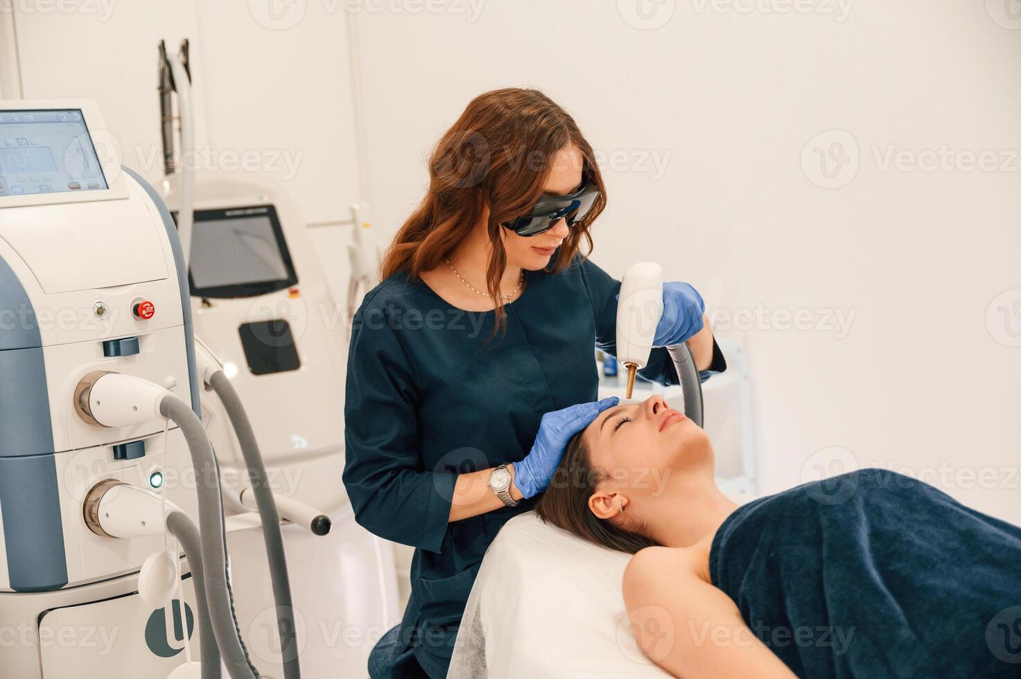 Lying ,down. Getting photo rejuvenation procedure at cosmetology clinic
