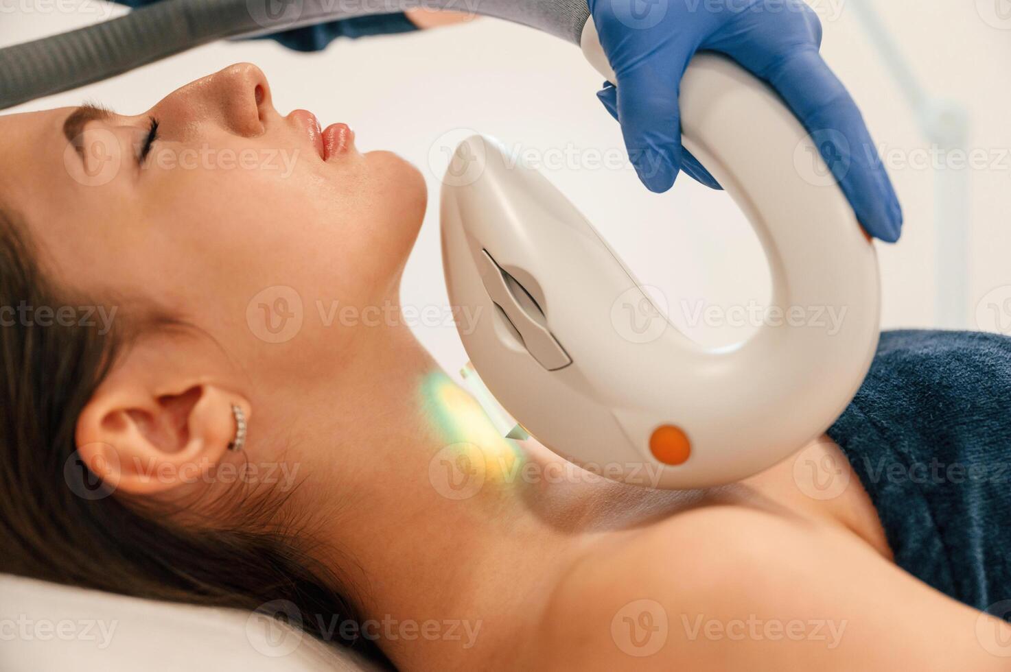 Woman is ,getting LPG hardware massage in beauty salon. Getting photo rejuvenation procedure at cosmetology clinic