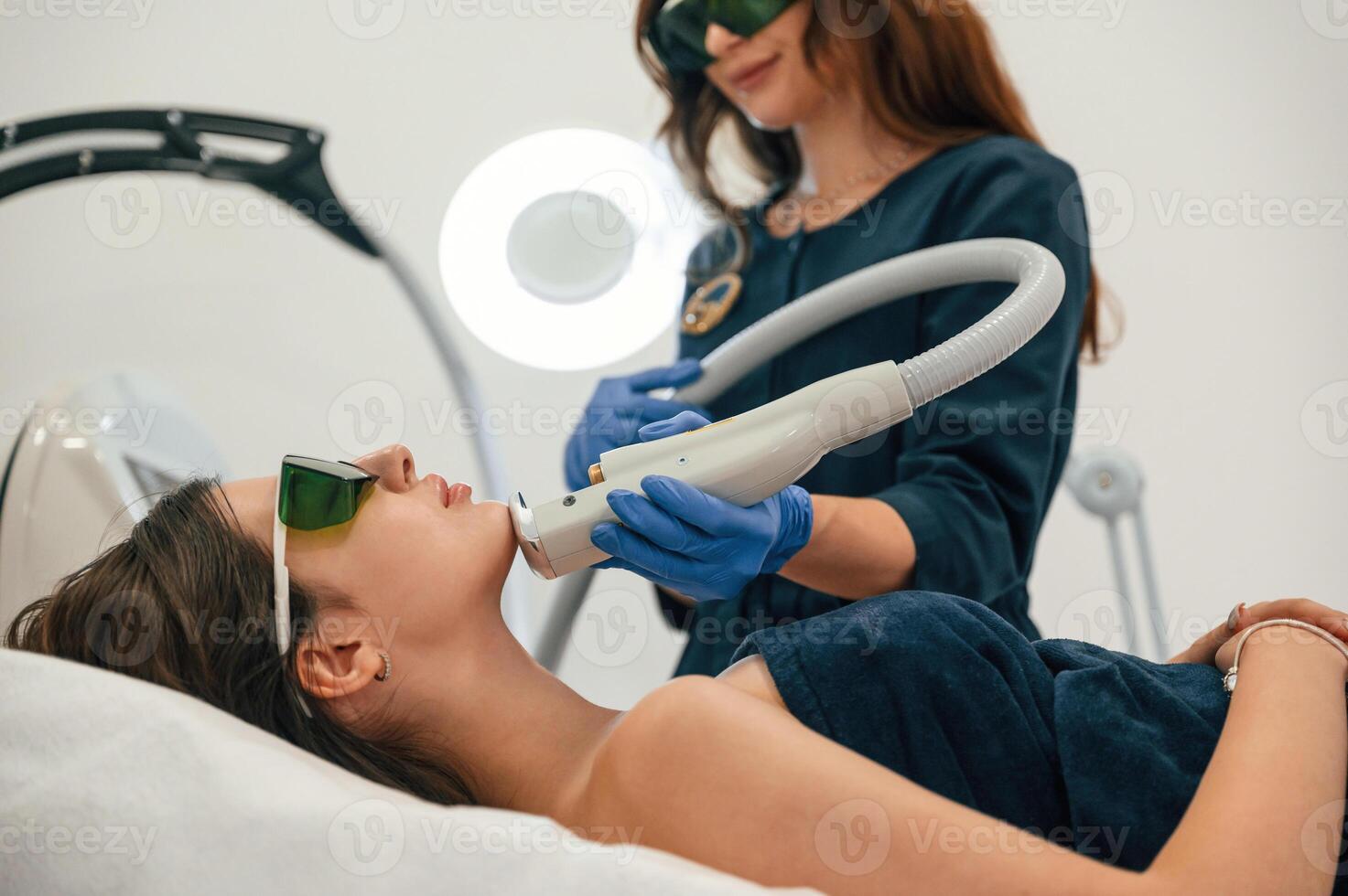 Professional occupation.. Getting photo rejuvenation procedure at cosmetology clinic. Women in beauty salon