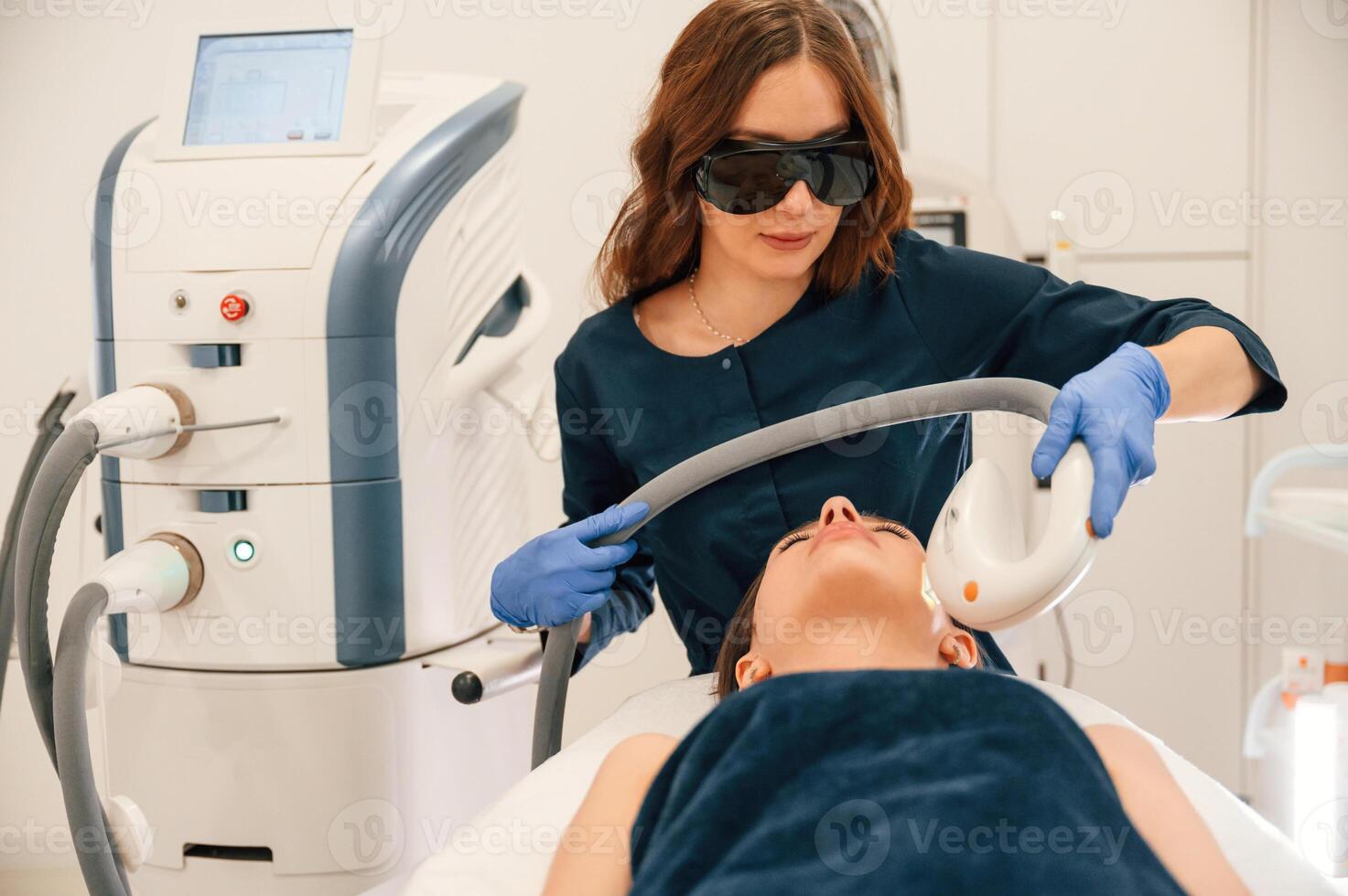 Lying, down. Getting photo rejuvenation procedure at cosmetology clinic