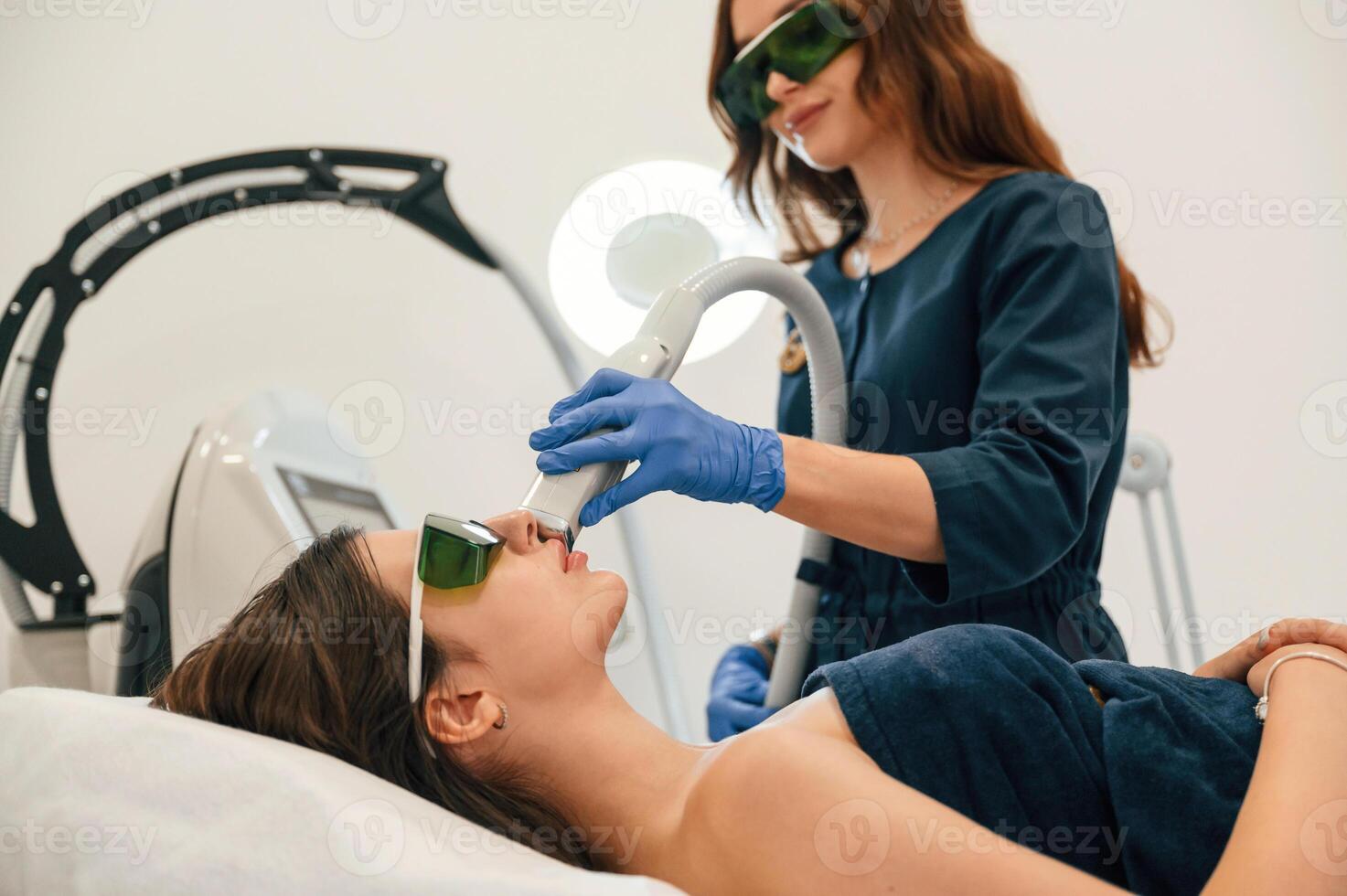 Professional, occupation. Getting photo rejuvenation procedure at cosmetology clinic. Women in beauty salon