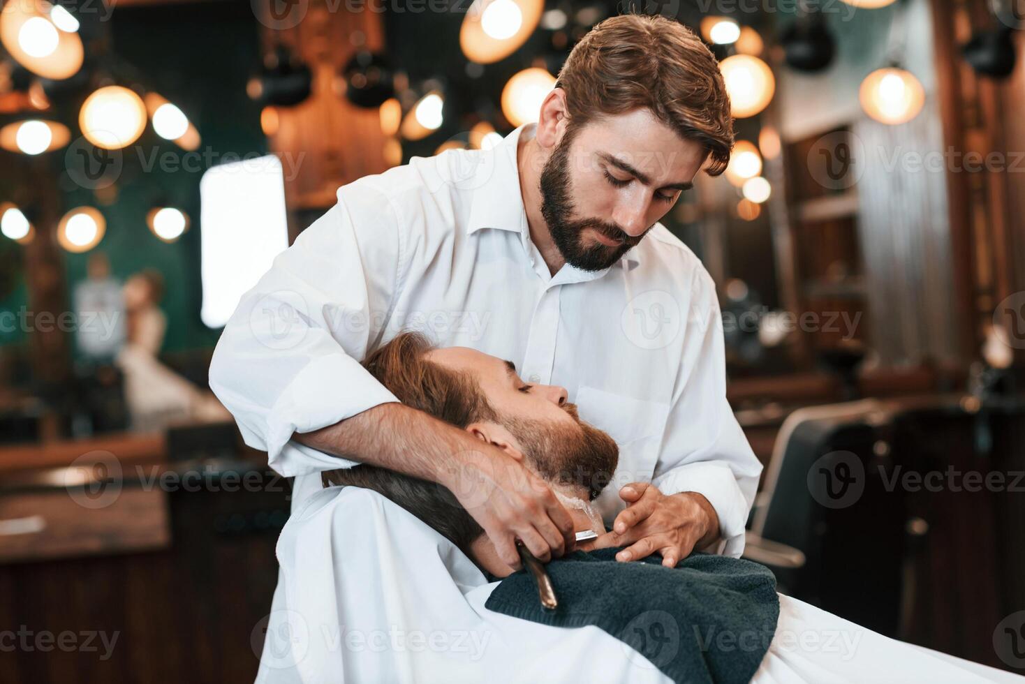 Sitting ,on the chair. Man ,is visiting modern barber shop. Modern style photo