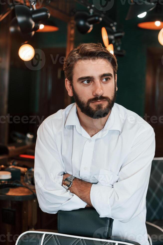Handsome man with, beard is in the barber shop photo