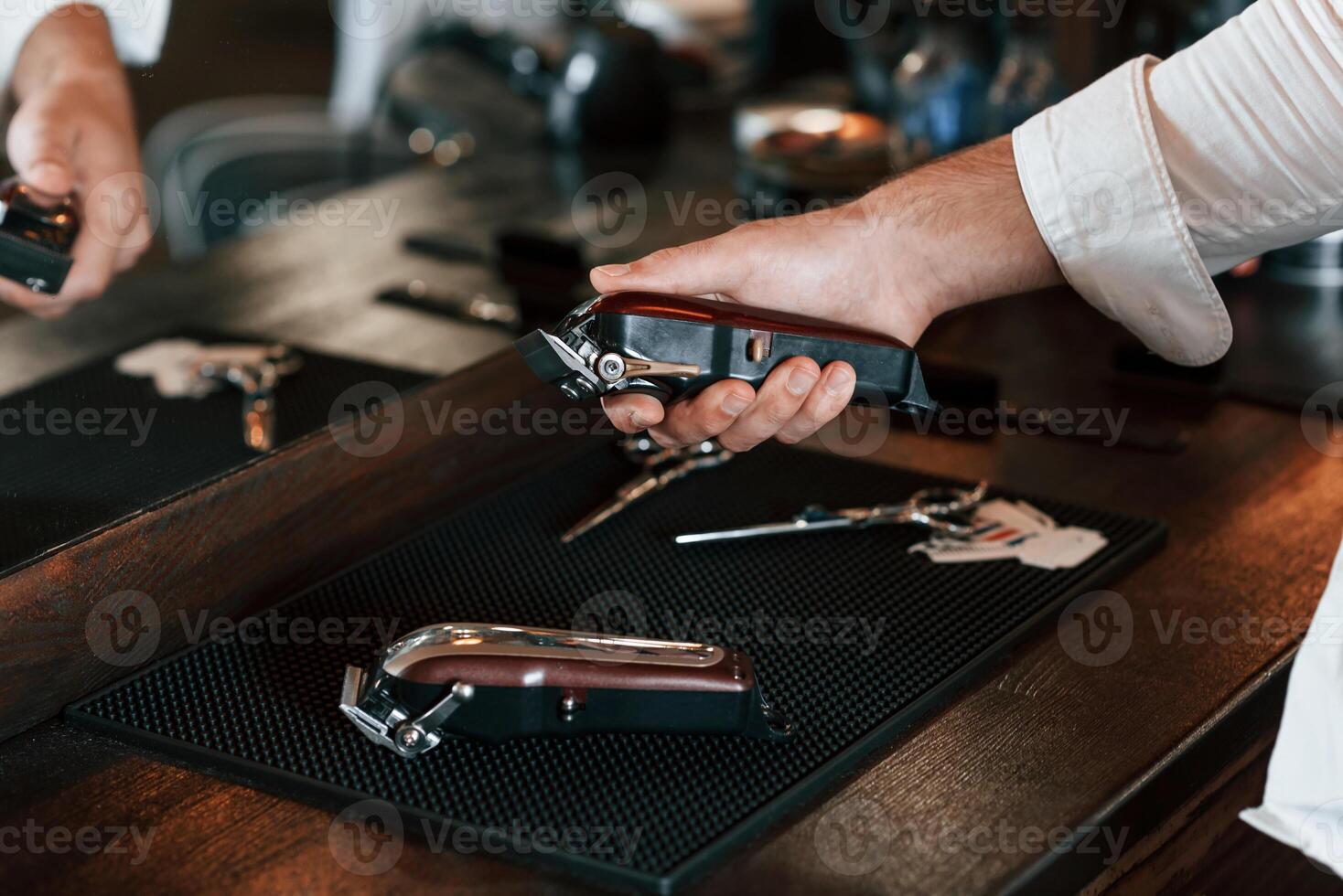 Close, up view of barber hand that is holding hair clipper photo