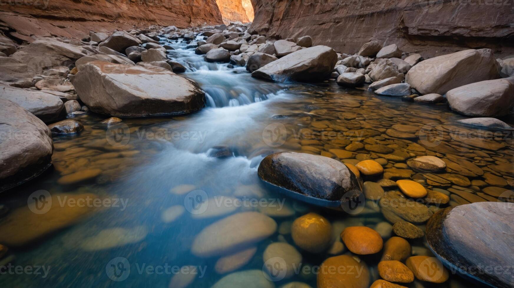 A serene river flows through a rocky canyon, showcasing nature's beauty and tranquility. photo