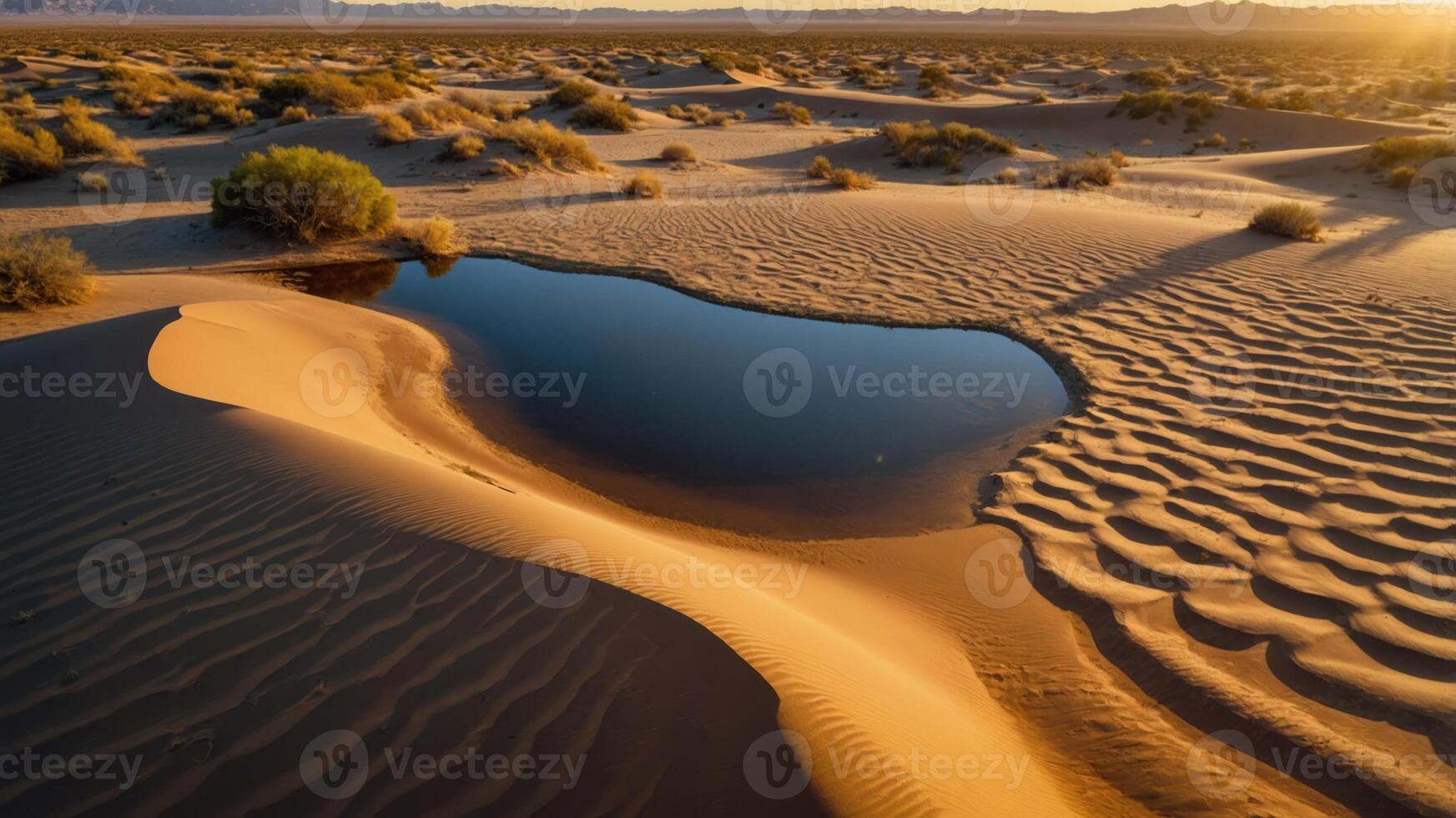 A serene desert landscape featuring sand dunes and a small reflective water pool. photo