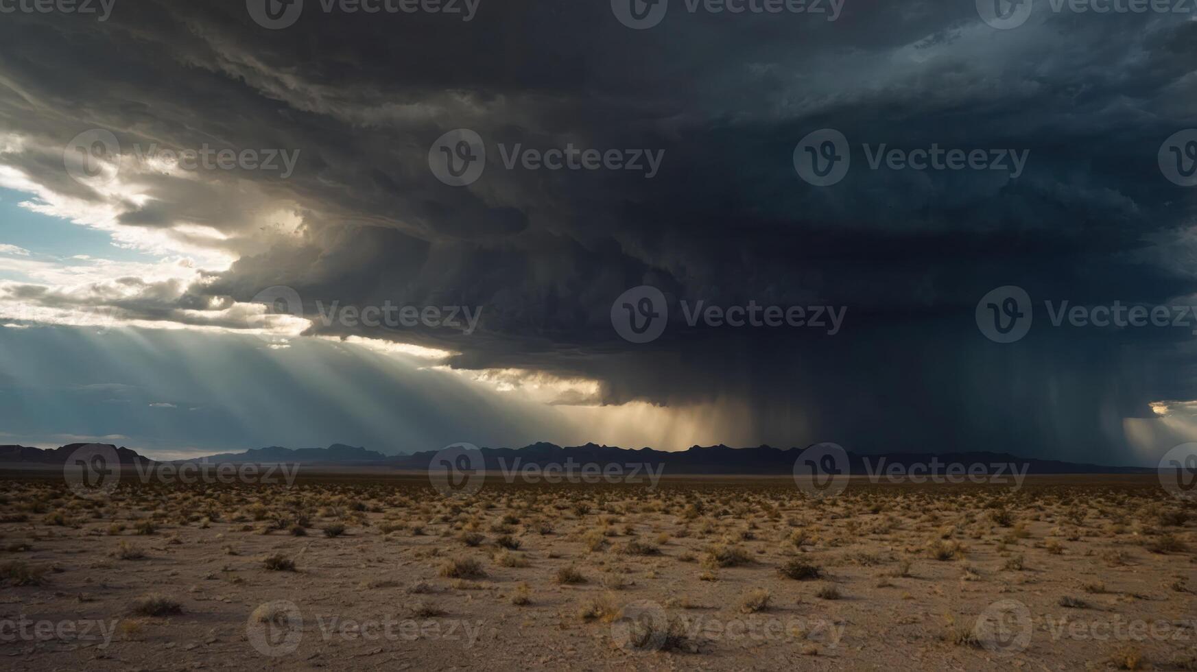Dramatic storm clouds over a barren landscape with rays of sunlight breaking through. photo