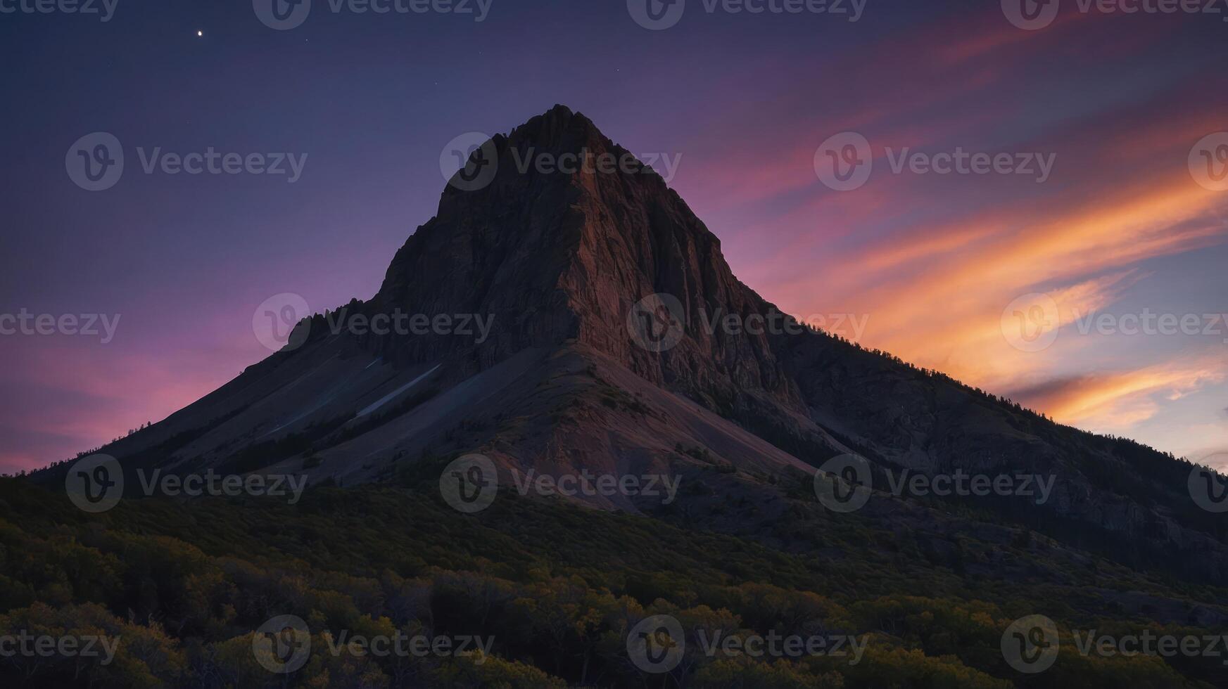 Majestic mountain silhouette against a colorful sunset sky. photo