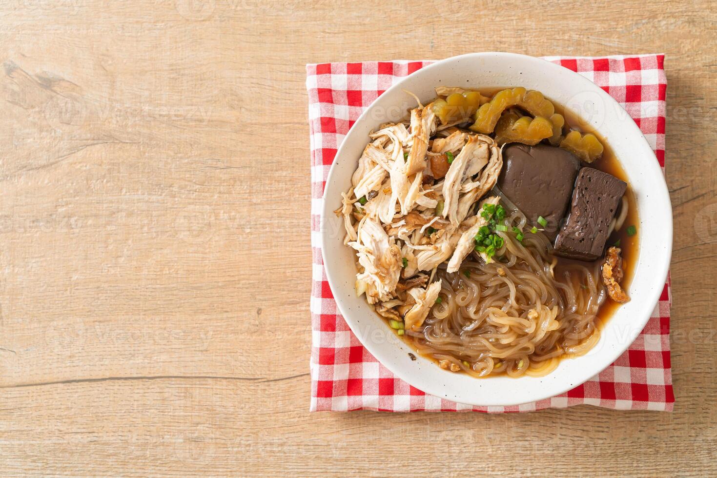 Stewed Chicken Noodle Soup Bowl on wooden background photo