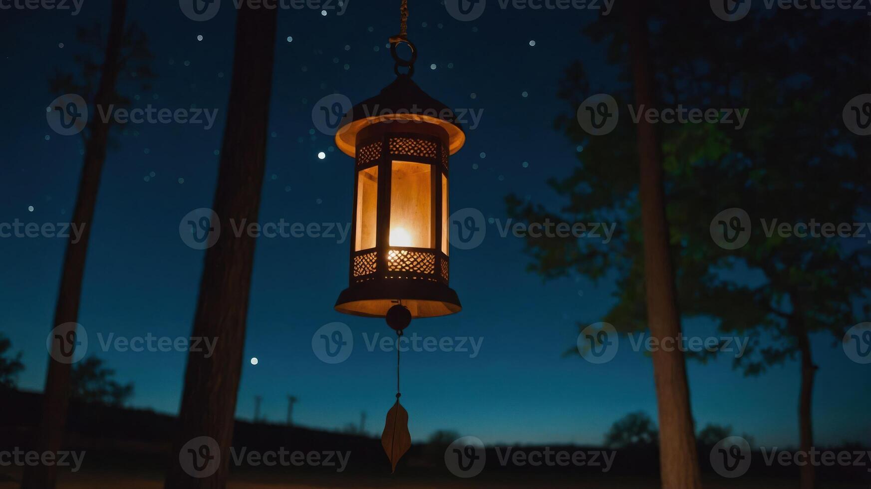 Hanging Lantern Illuminates a Dark Night Forest Scene with Starry Sky photo