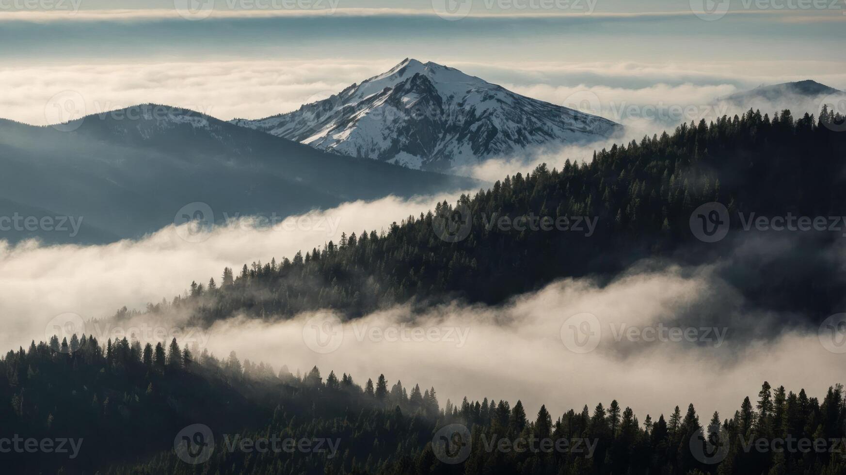 Snowy Mountain Peak Emerging Above Foggy Forest Landscape Scenery photo