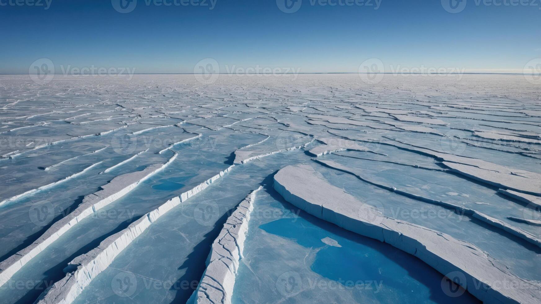Vast Ice Field with Cracks and Pools of Water Under Blue Sky photo