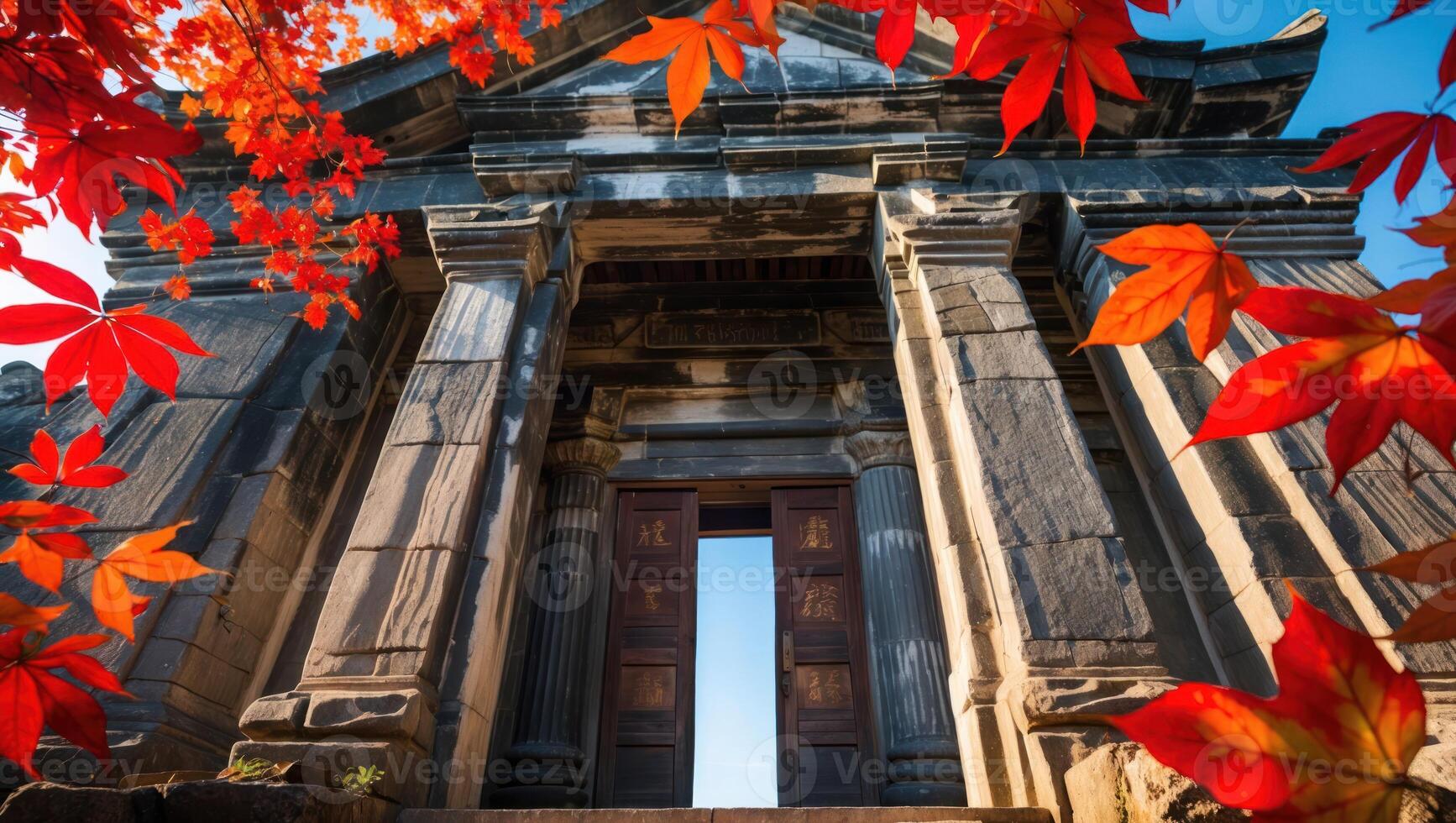 Ancient Stone Structure Framed by Vivid Red Fall Leaves photo