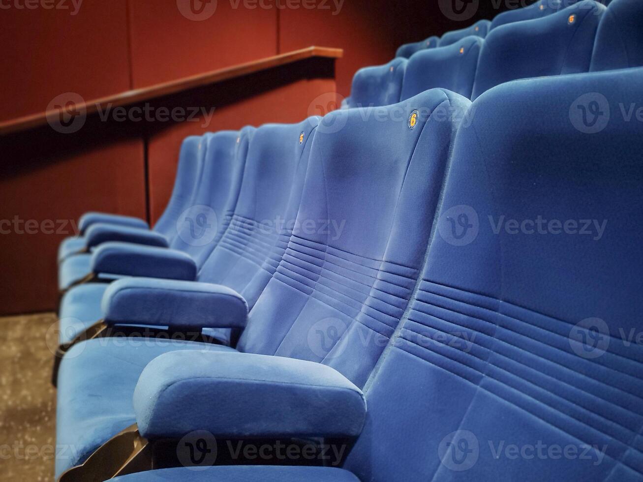 Rows of empty blue seats in a cinema hall for a large number of people. Cinema and theater halls for watching shows. photo