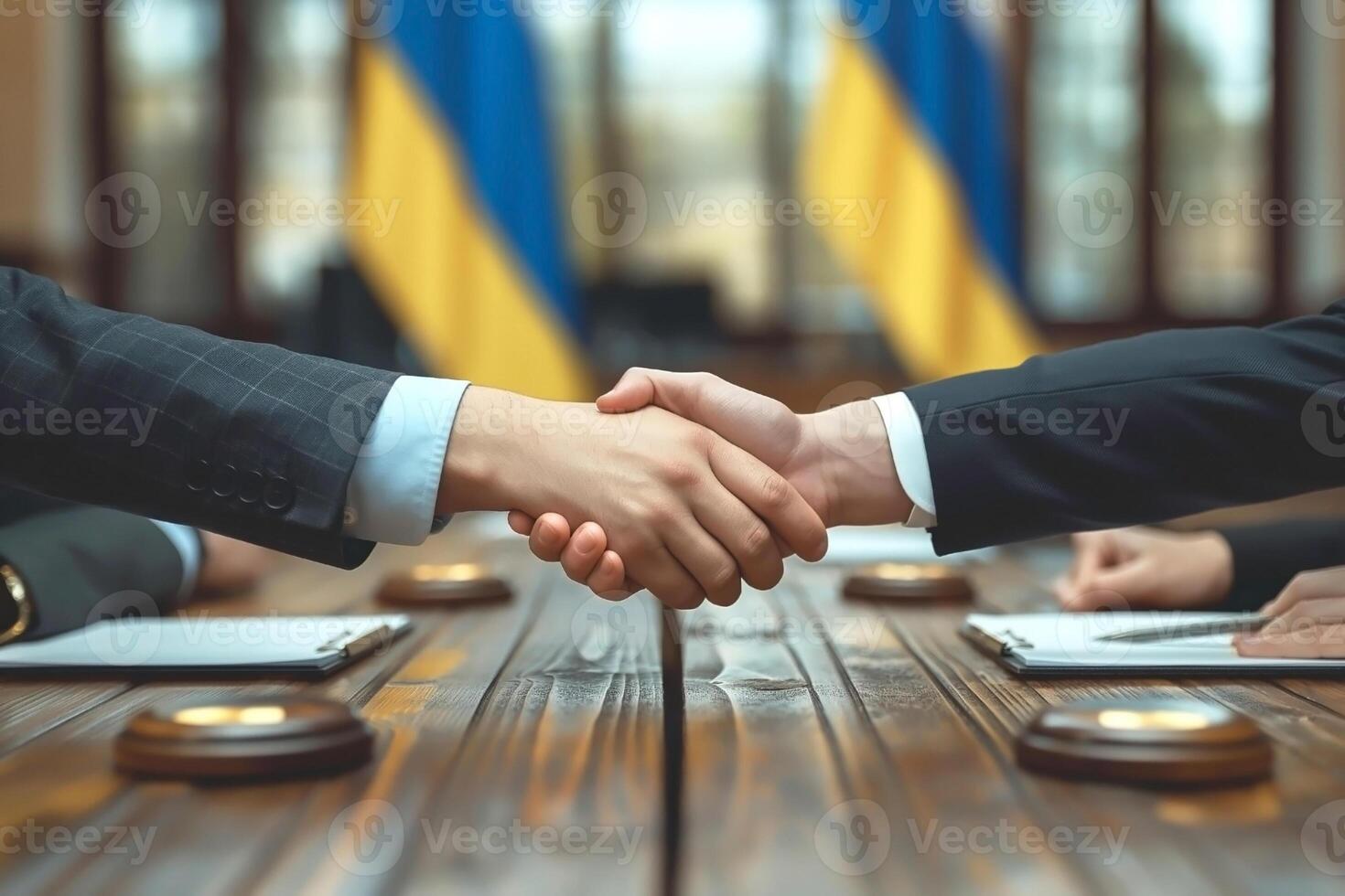 Two business professionals shake hands in a formal setting, symbolizing partnership and agreement. photo