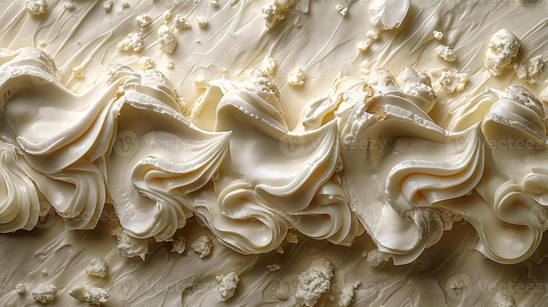 Close-up of swirls of creamy white frosting, showcasing smooth texture and delicate peaks. photo
