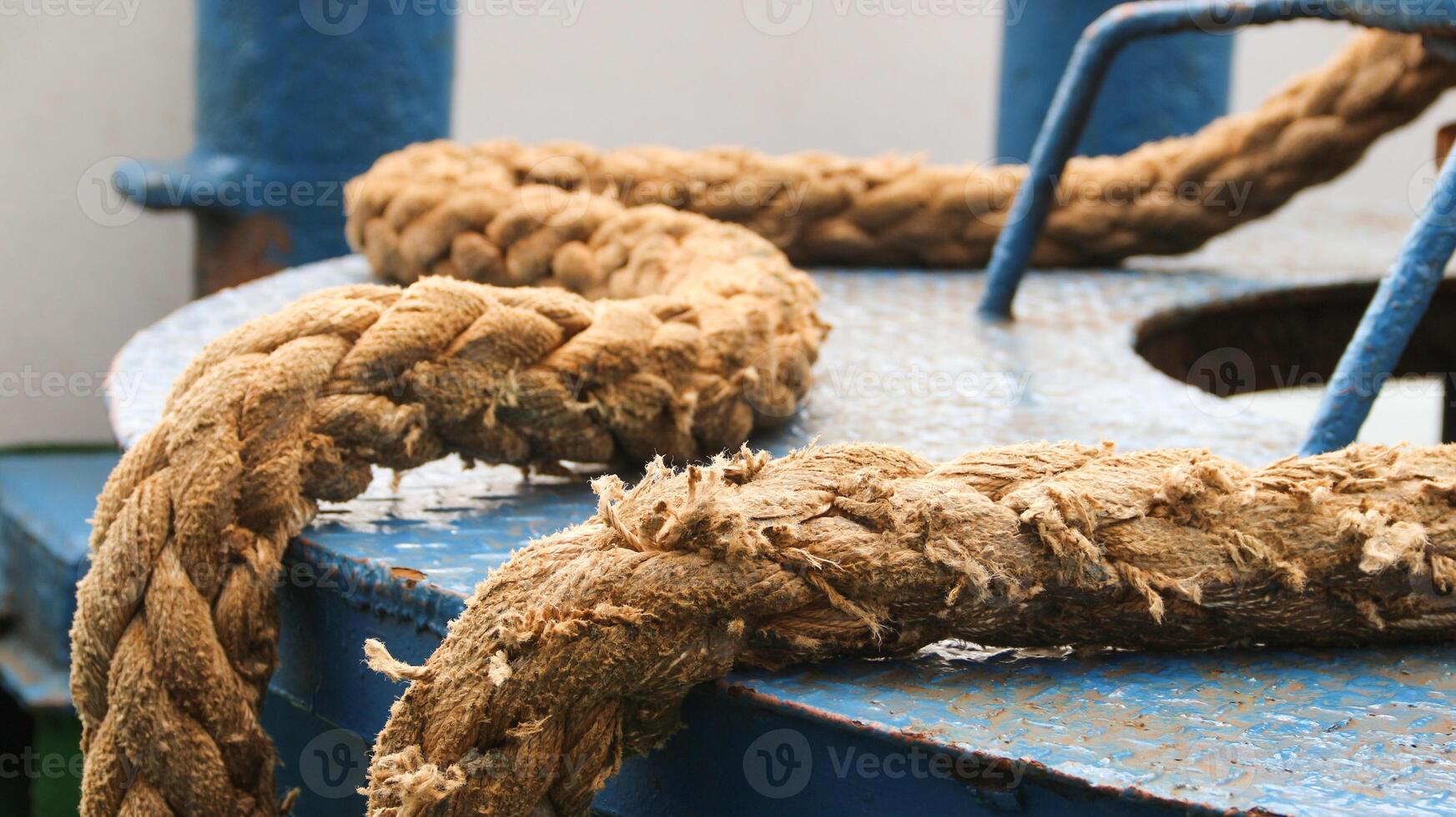 Very large ferry ropes are used to tie up ships when they are anchored in a harbor. photo