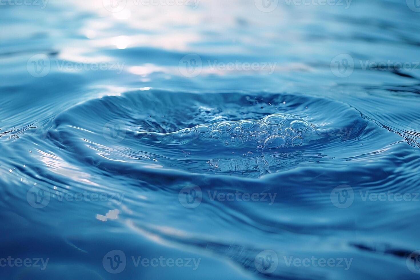 Close-up of water ripples and bubbles creating serene patterns in clear blue water, capturing tranquility and fluid motion. photo