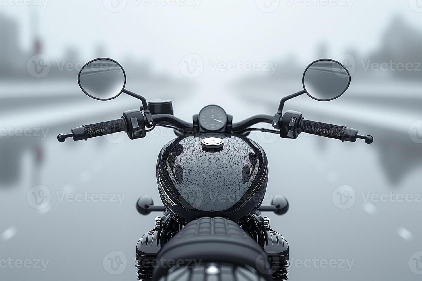 A sleek black motorcycle's handlebars are viewed from the front, surrounded by a misty road atmosphere. photo