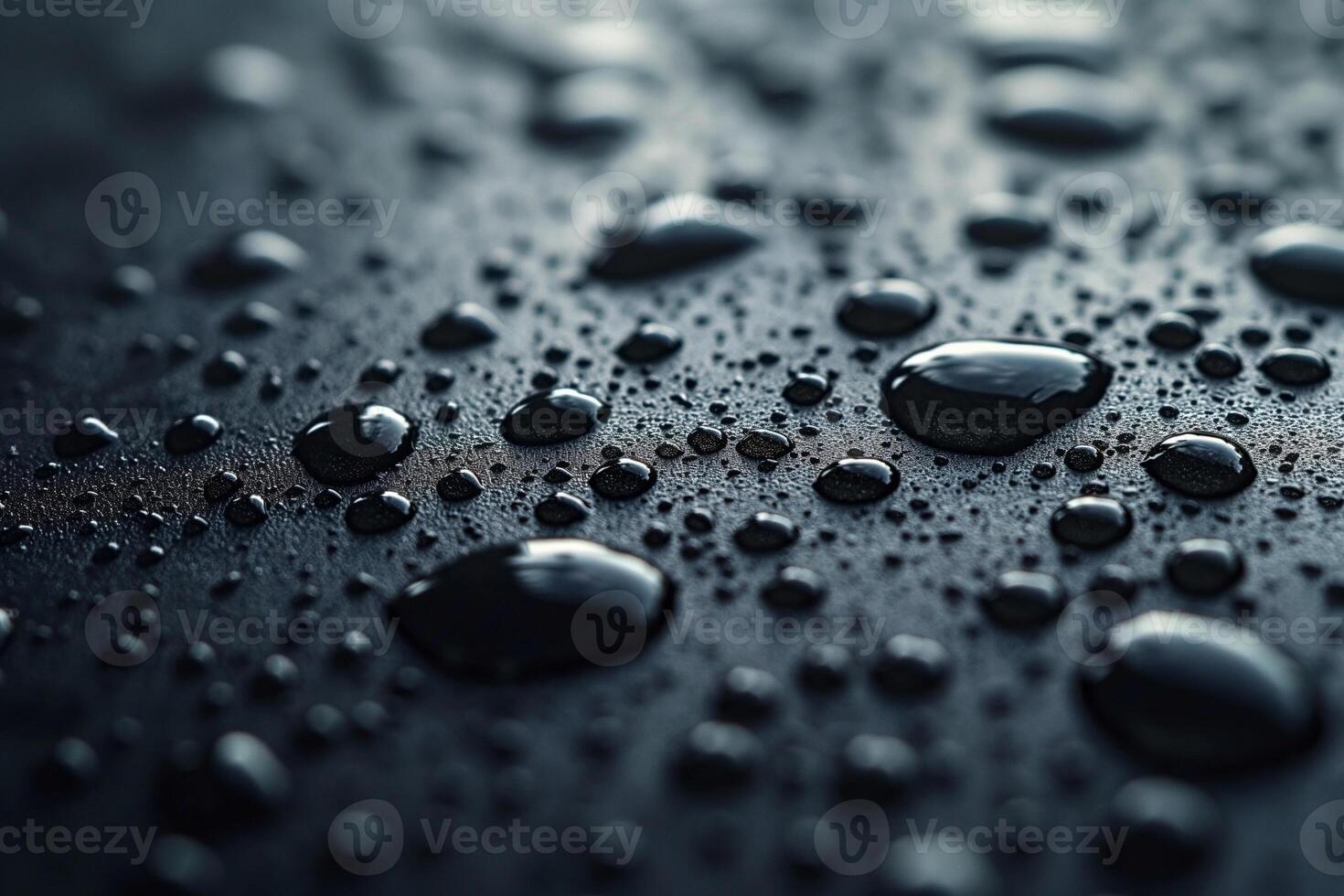 Close-up of glistening water droplets on a sleek black surface, creating a moody and textured scene. photo