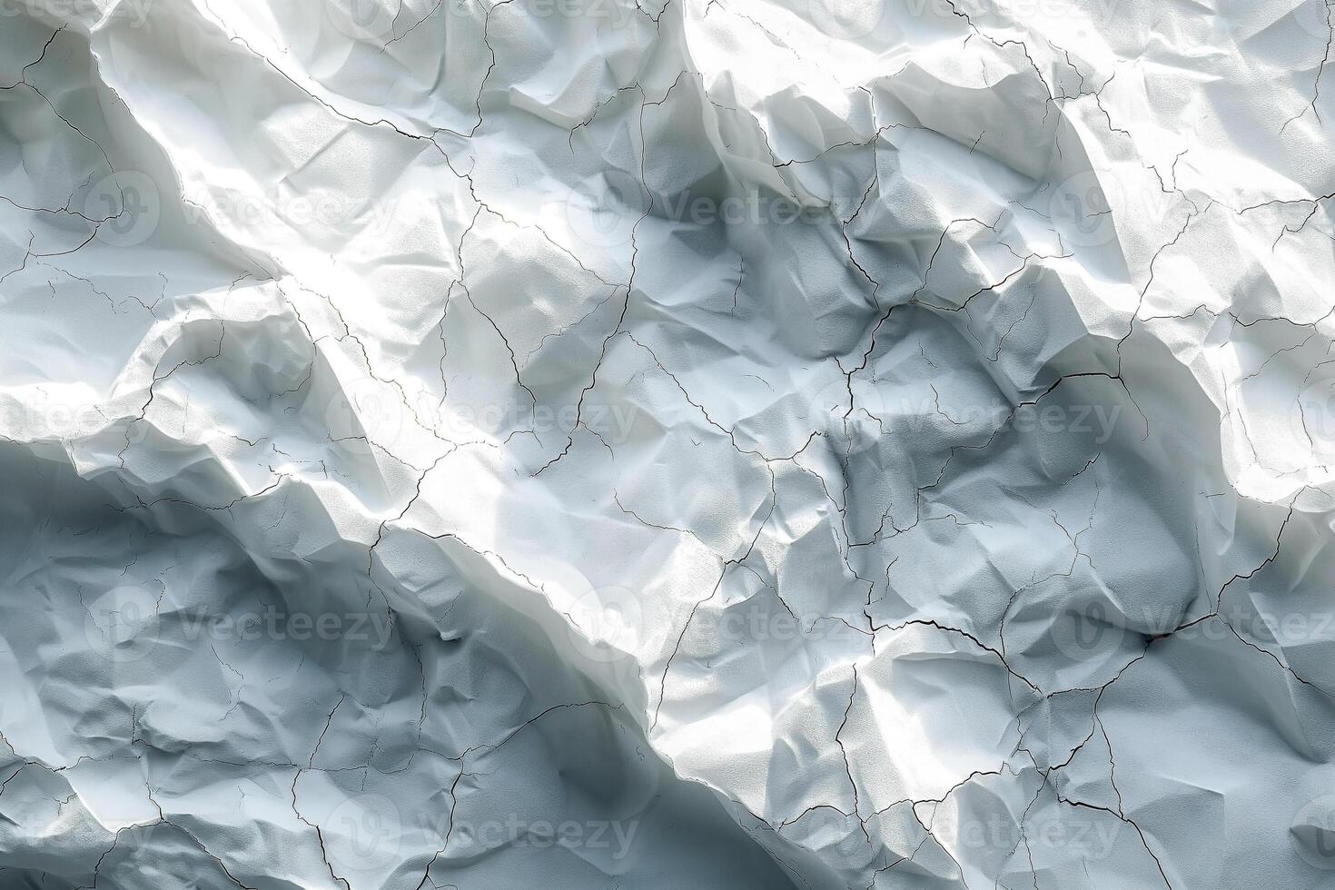 Textured white crumpled paper illustrating natural light and shadow contrasts. photo
