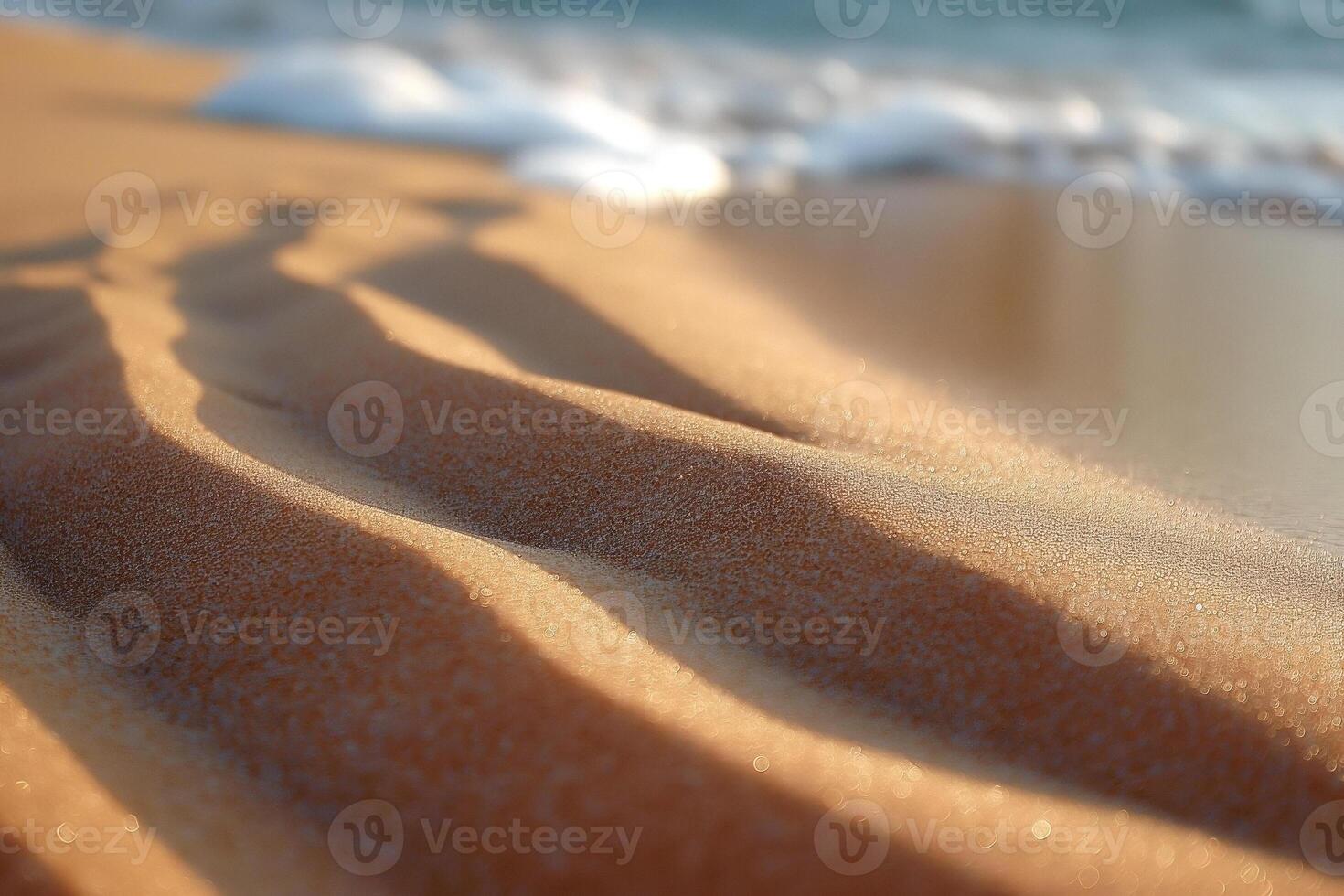Gentle waves wash over fine golden sand, creating serene patterns and reflections of sunlight. photo