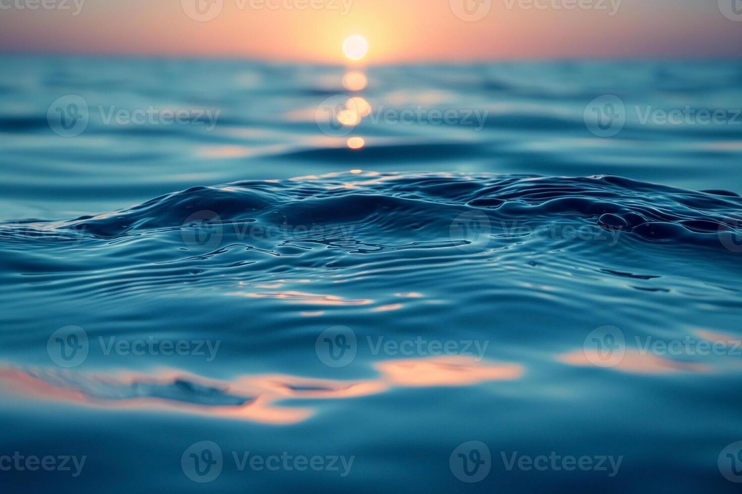 Serene ocean waves catch the golden hues of the setting sun, creating a tranquil atmosphere. photo