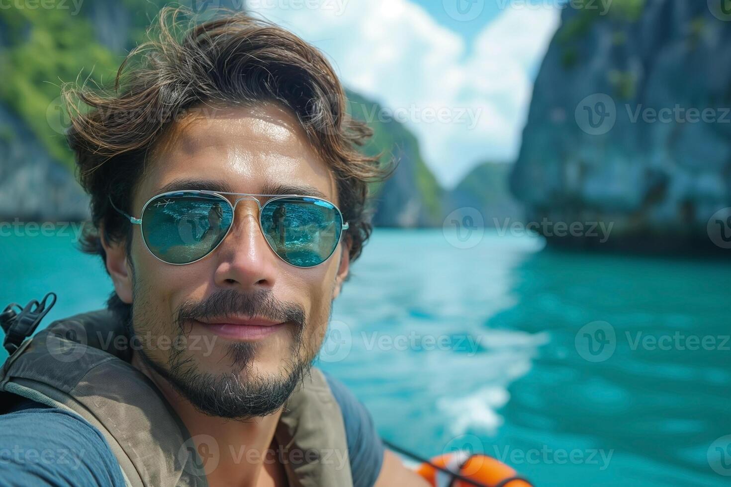 A young Caucasian man enjoys a serene boat ride in turquoise waters surrounded by lush greenery. photo