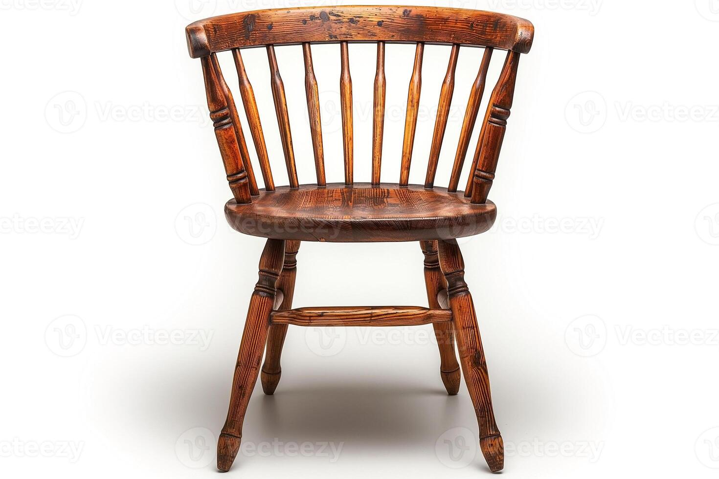 A rustic wooden chair with a classic spindle-back design, showcasing its natural grain and weathered finish. photo