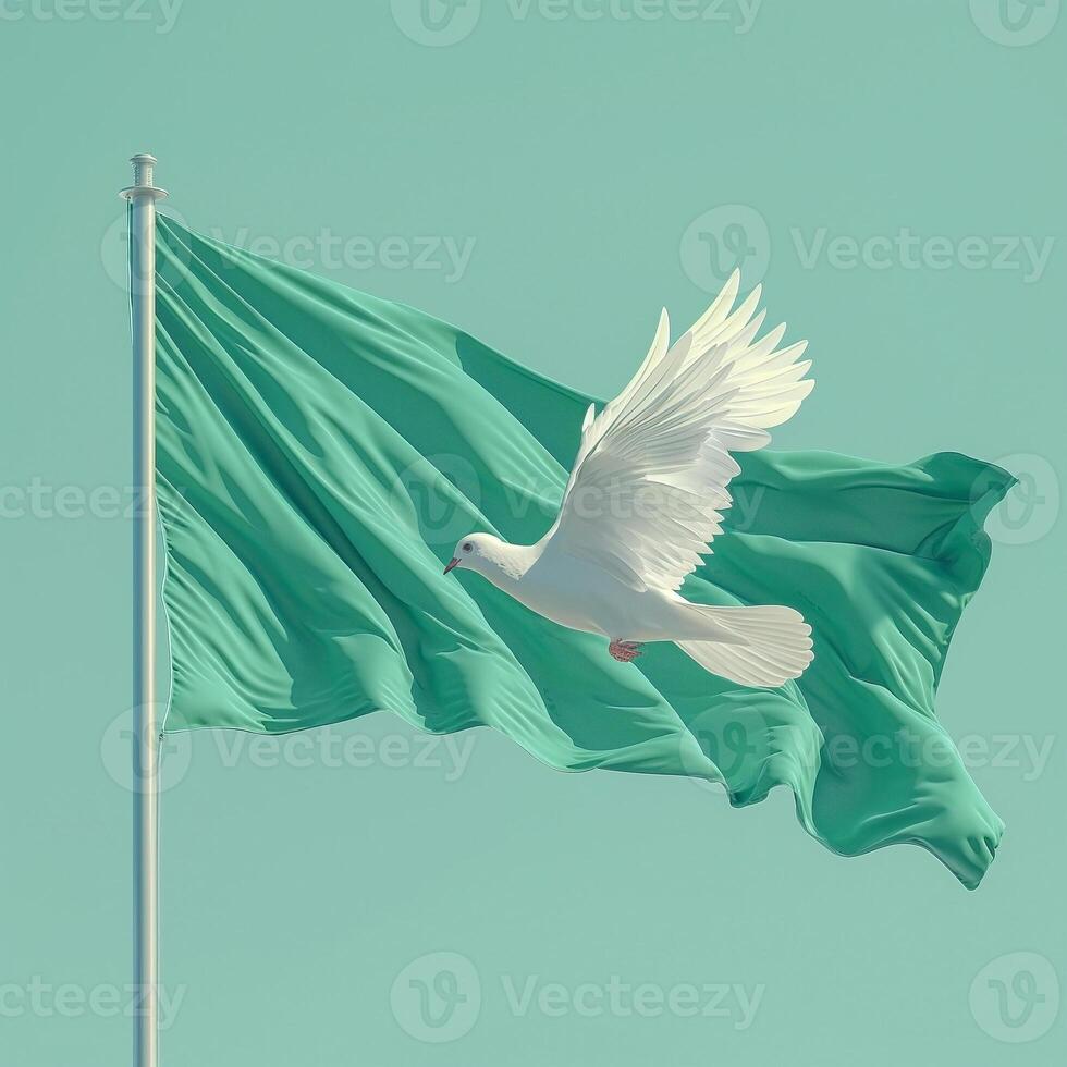 A graceful white dove soars next to a green flag, symbolizing peace and hope in a serene atmosphere. photo