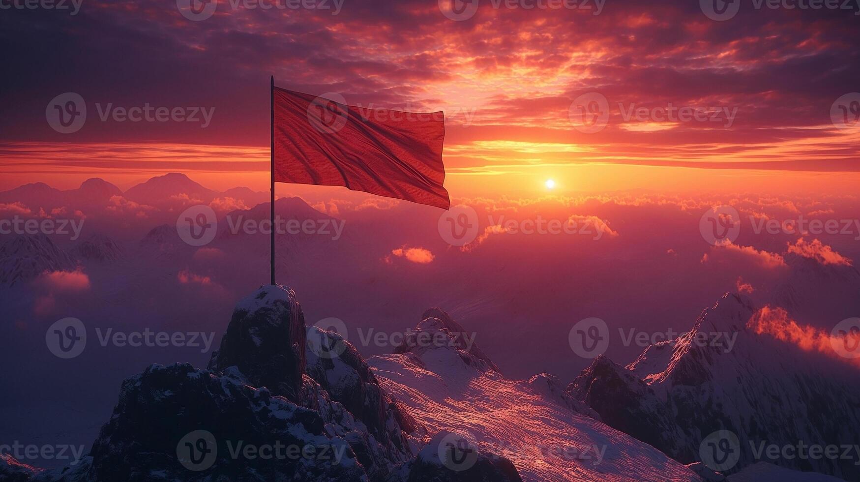 A vibrant sunset casts golden hues over a mountaintop with a red flag waving proudly atop a rocky peak. photo