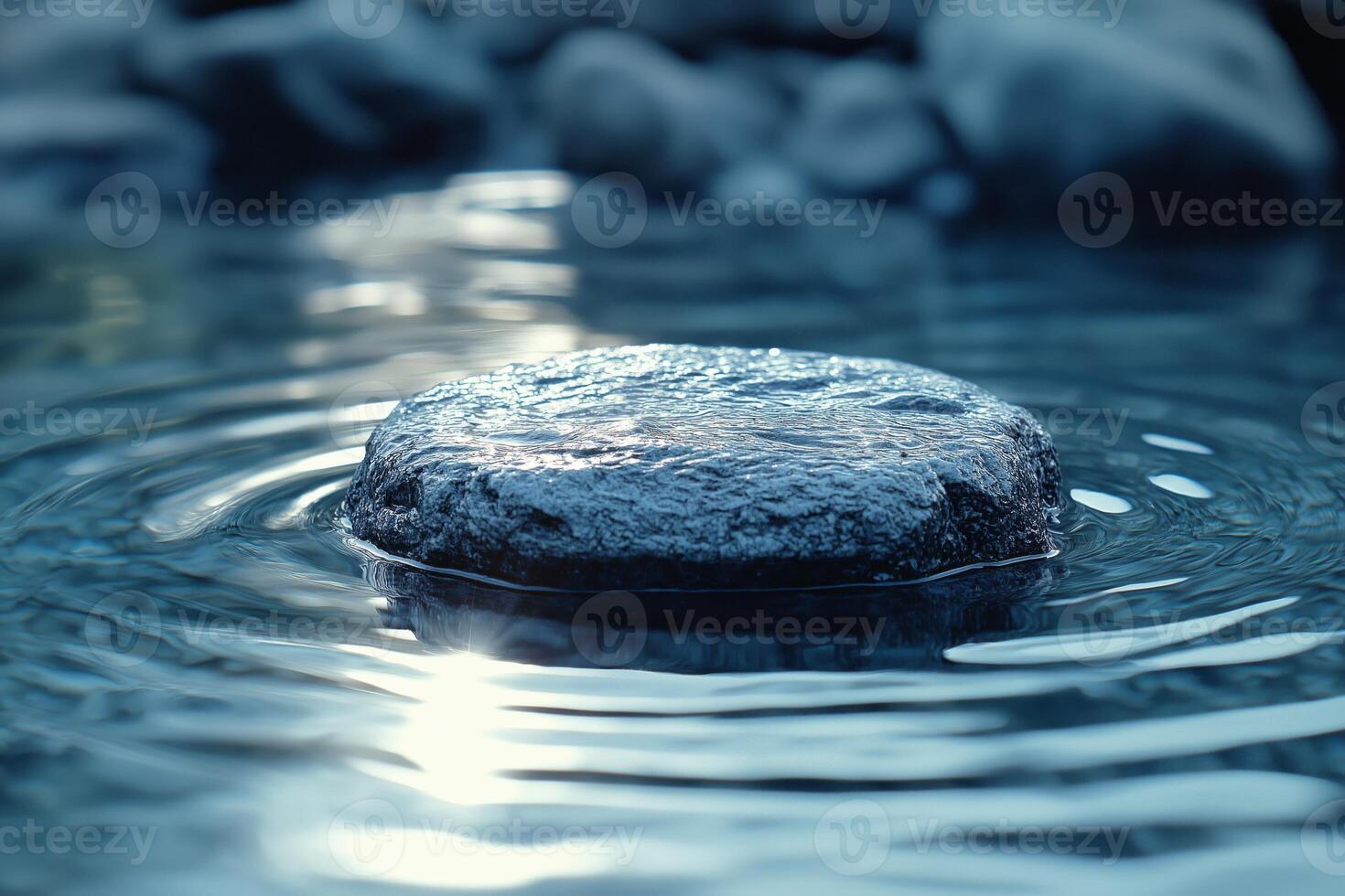 A tranquil stone rests on the surface of rippling water, reflecting soft light and creating a serene atmosphere. photo