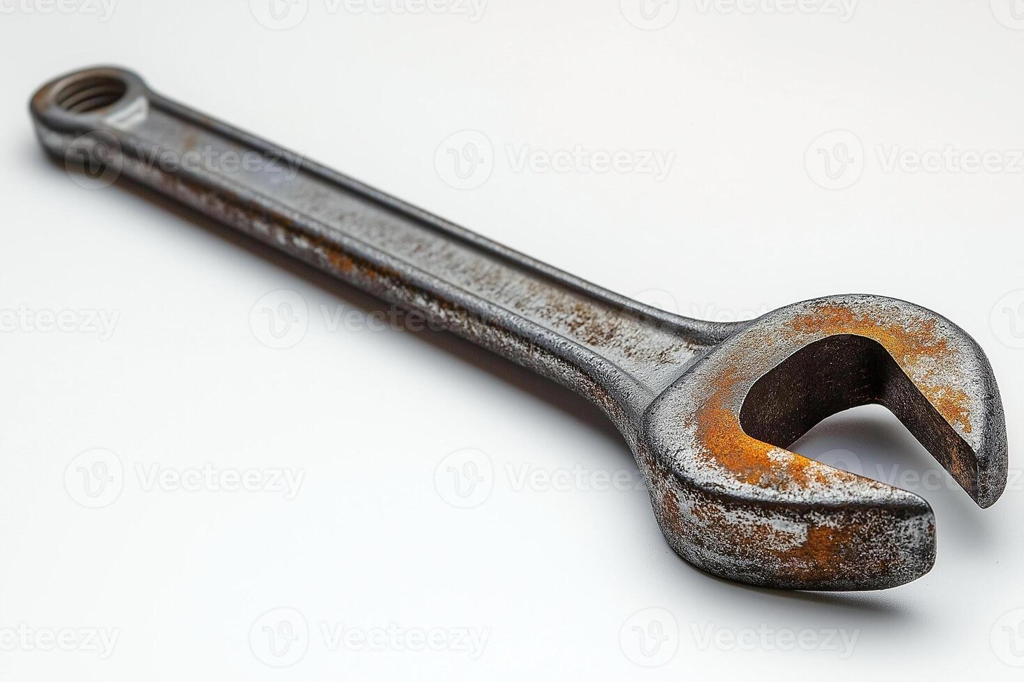 A close-up view of an old, rusty adjustable wrench showcasing its detailed texture and wear. photo