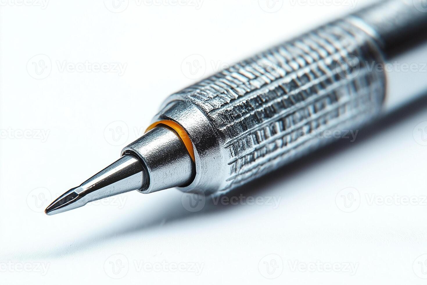 Close-up of a sleek silver mechanical pencil highlighting its precision tip and textured grip. photo