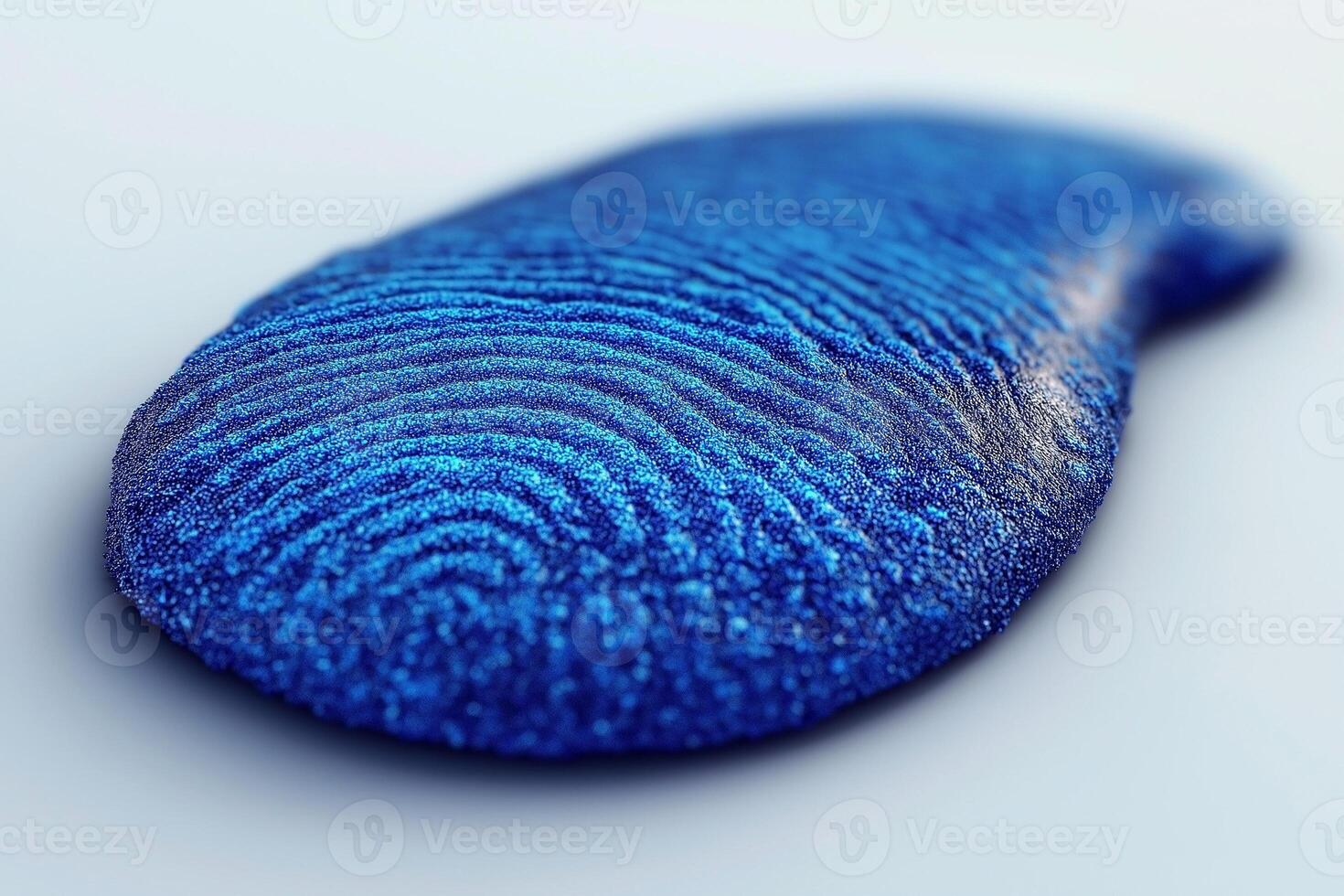 A close-up view of a vibrant blue fingerprint sculpture, showcasing intricate swirl patterns and a glossy texture. photo
