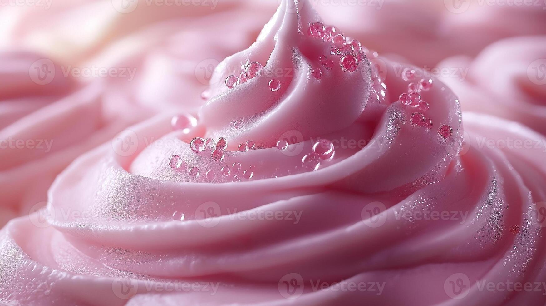 A close-up of creamy pink frosting adorned with glistening droplets, showcasing a delightful, sweet-themed dessert. photo