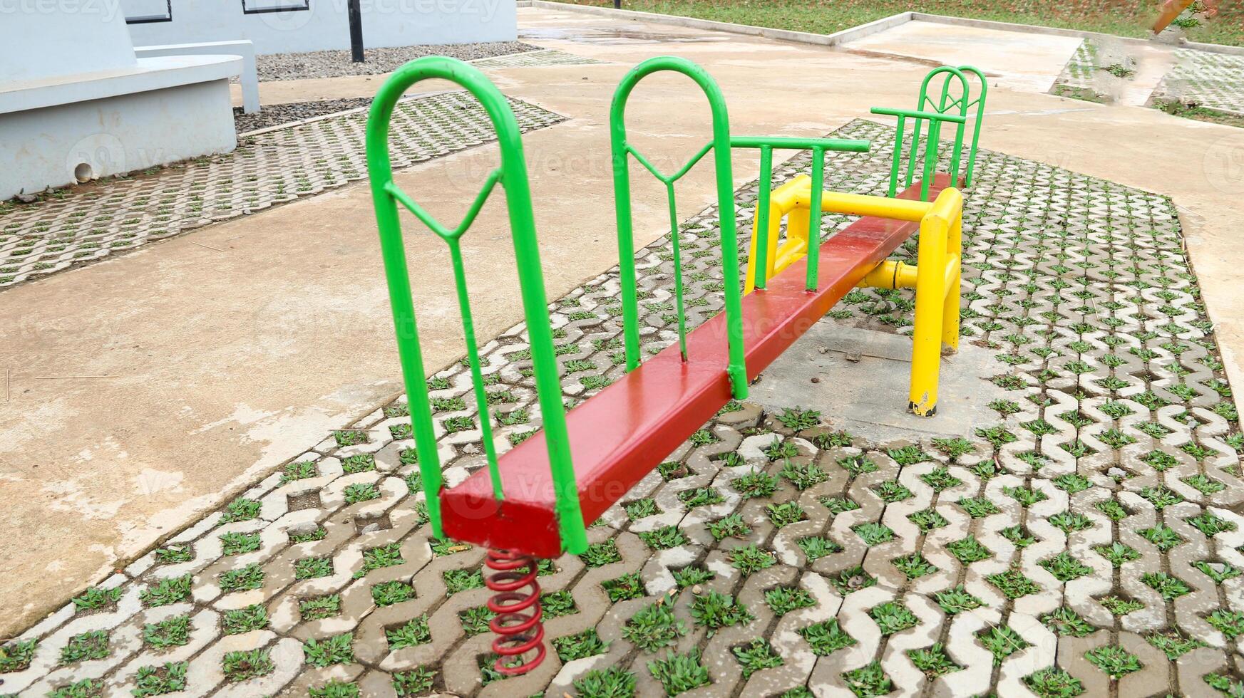 The classic seesaw consists of a long board mounted on a pivot point in the center. photo