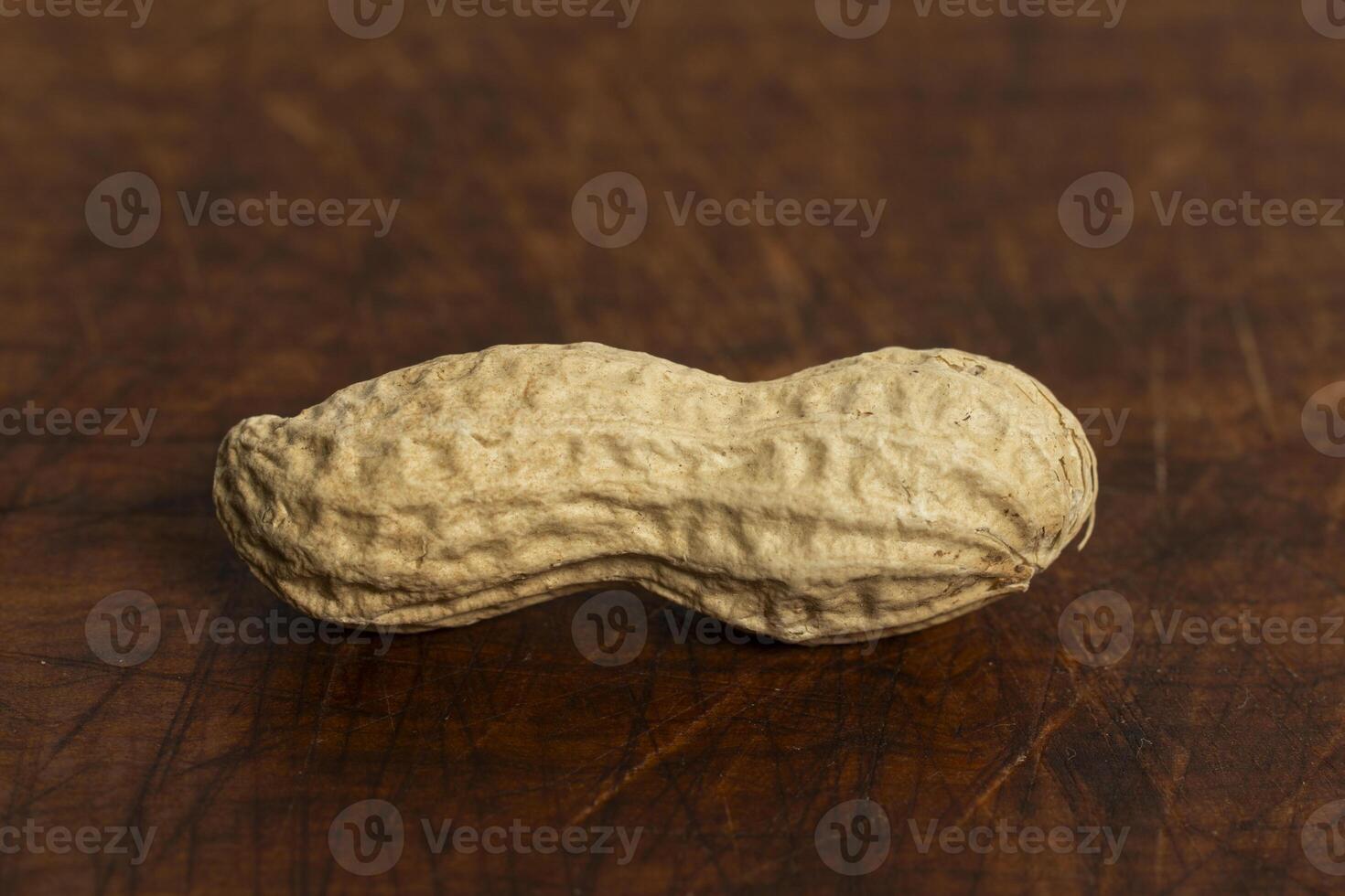 Peanut on a brown wooden background photo