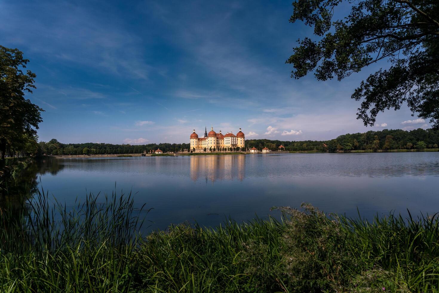 Moritzburg, Germany-august 17, 2022-View of Moritzburg castle surrounded by the lake on a sunny day. photo