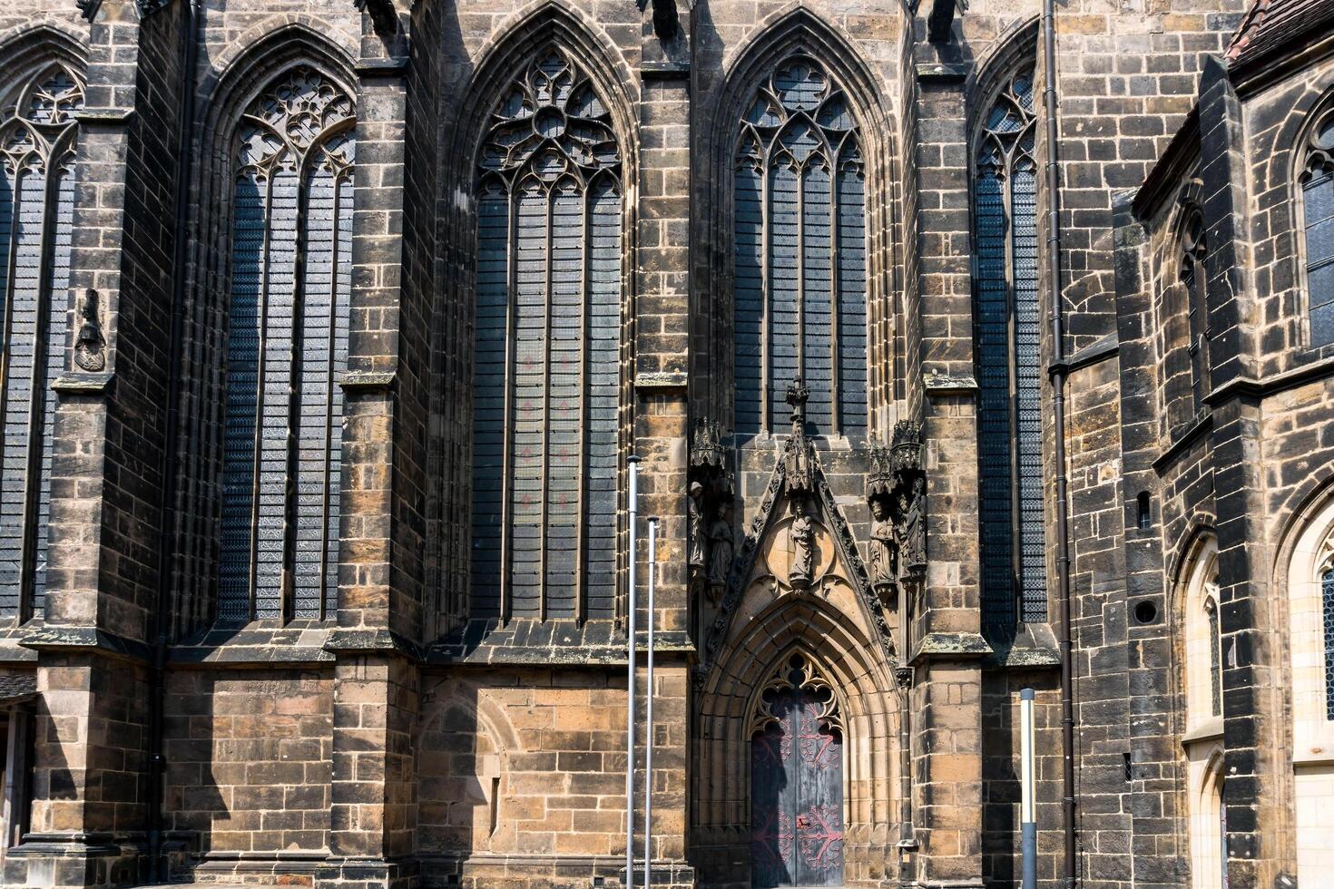 Meissen, Germany-august 17, 2022-small side entrance and tall windowsof Meissen Cathedral on a sunny day photo