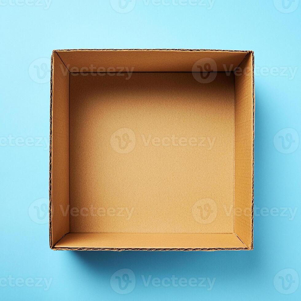 An empty cardboard box on a blue background photo
