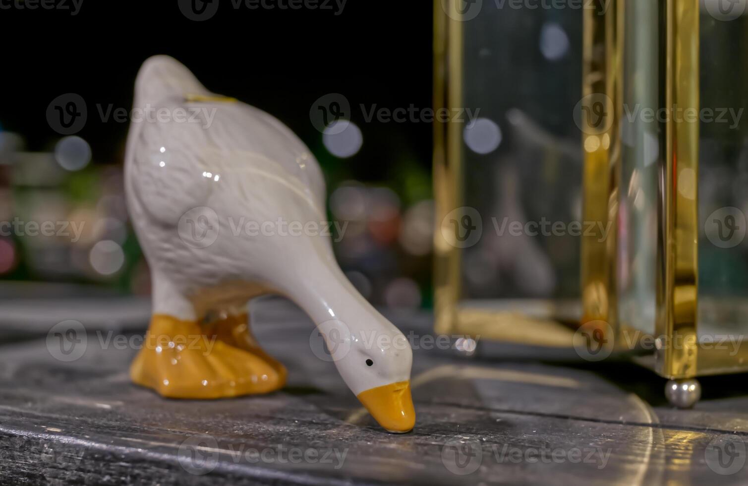 Ceramic Duck Figurine on Wooden Surface photo